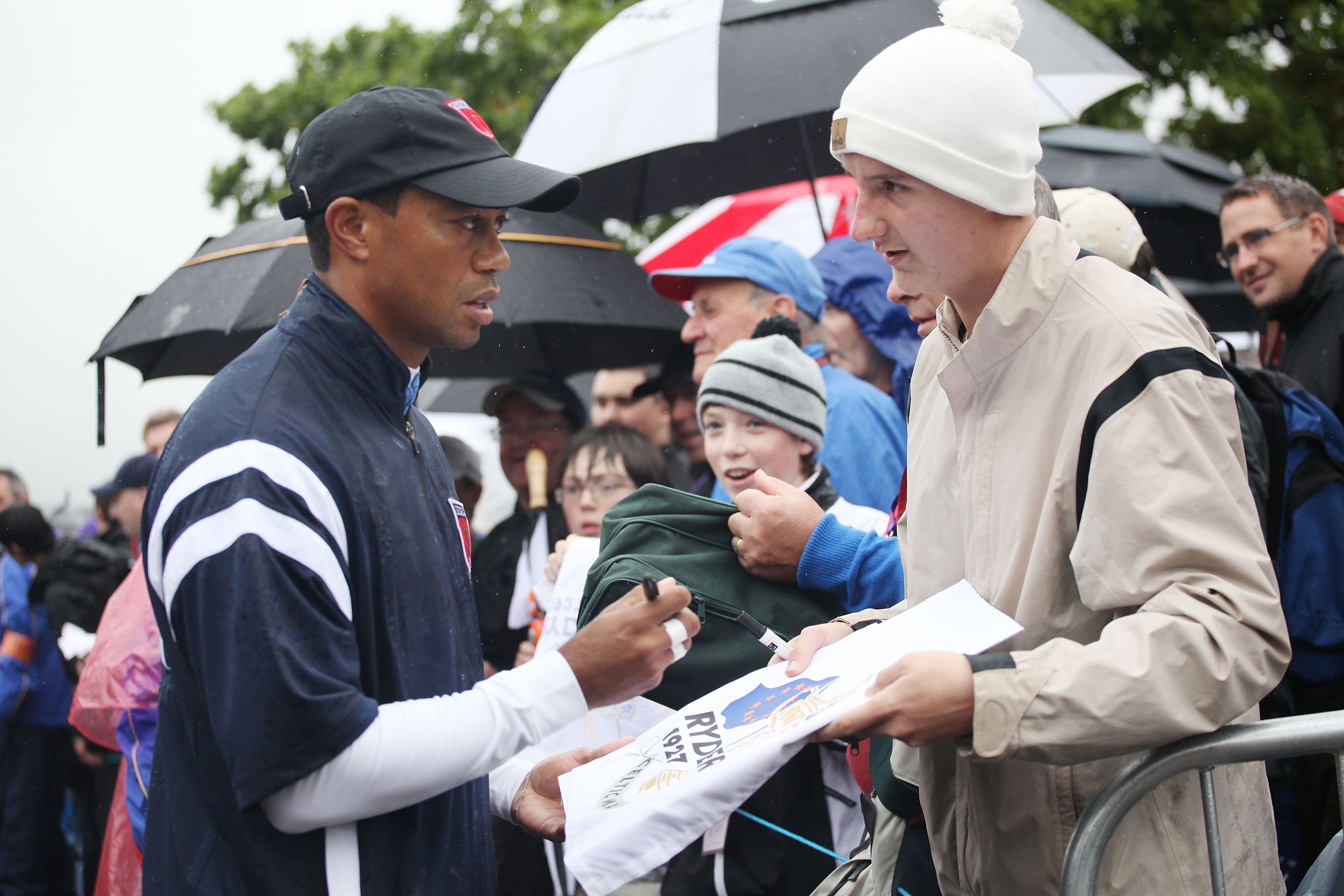 NEWPORT, WALES - SEPTEMBER 29:  Tiger Woods signs autographs for fans during a practice round prior to the 2010 Ryder Cup at the Celtic Manor Resort on September 29, 2010 in Newport, Wales.  (Photo by Jamie Squire/Getty Images)