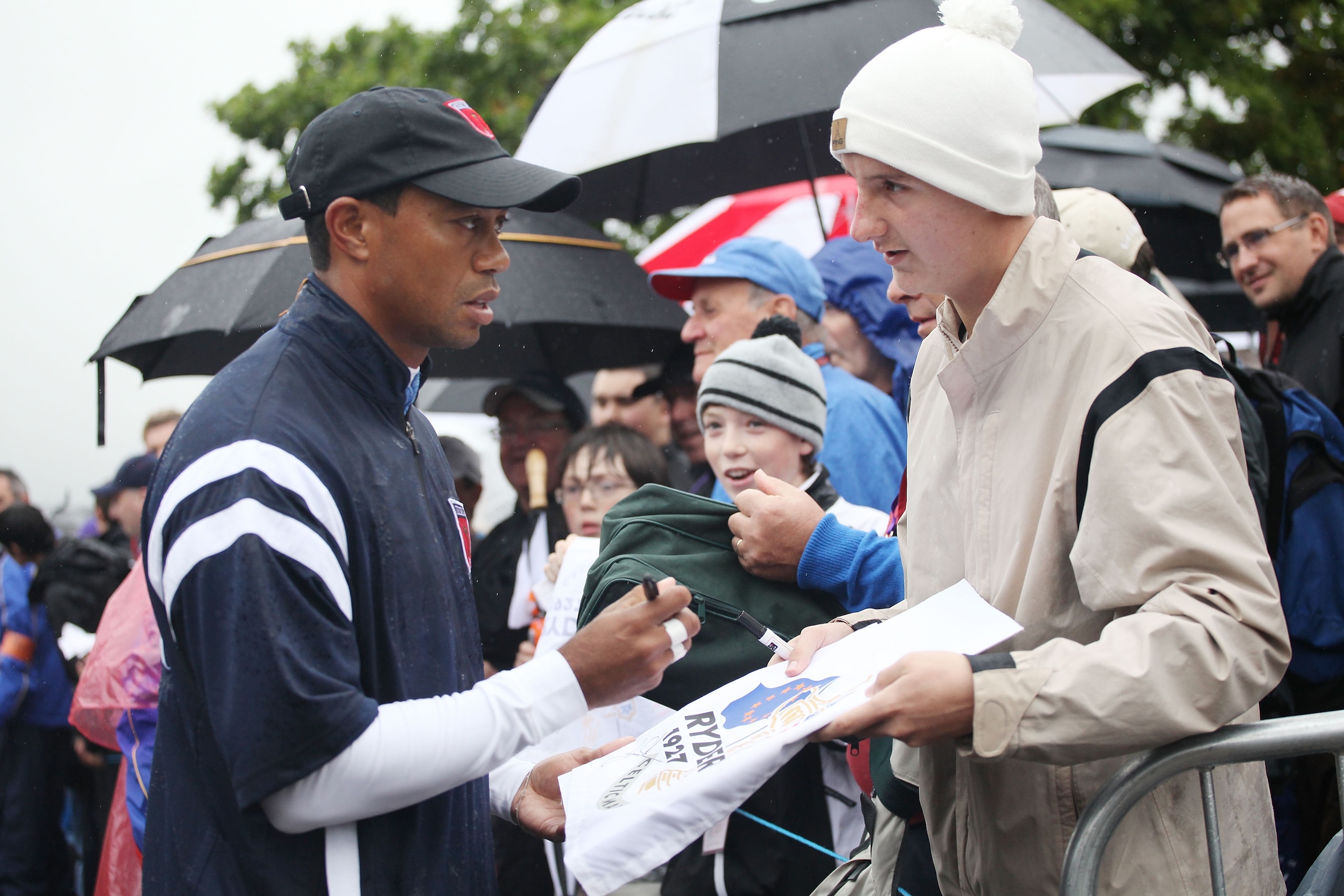 NEWPORT, WALES - SEPTEMBER 29:  Tiger Woods signs autographs for fans during a practice round prior to the 2010 Ryder Cup at the Celtic Manor Resort on September 29, 2010 in Newport, Wales.  (Photo by Jamie Squire/Getty Images)