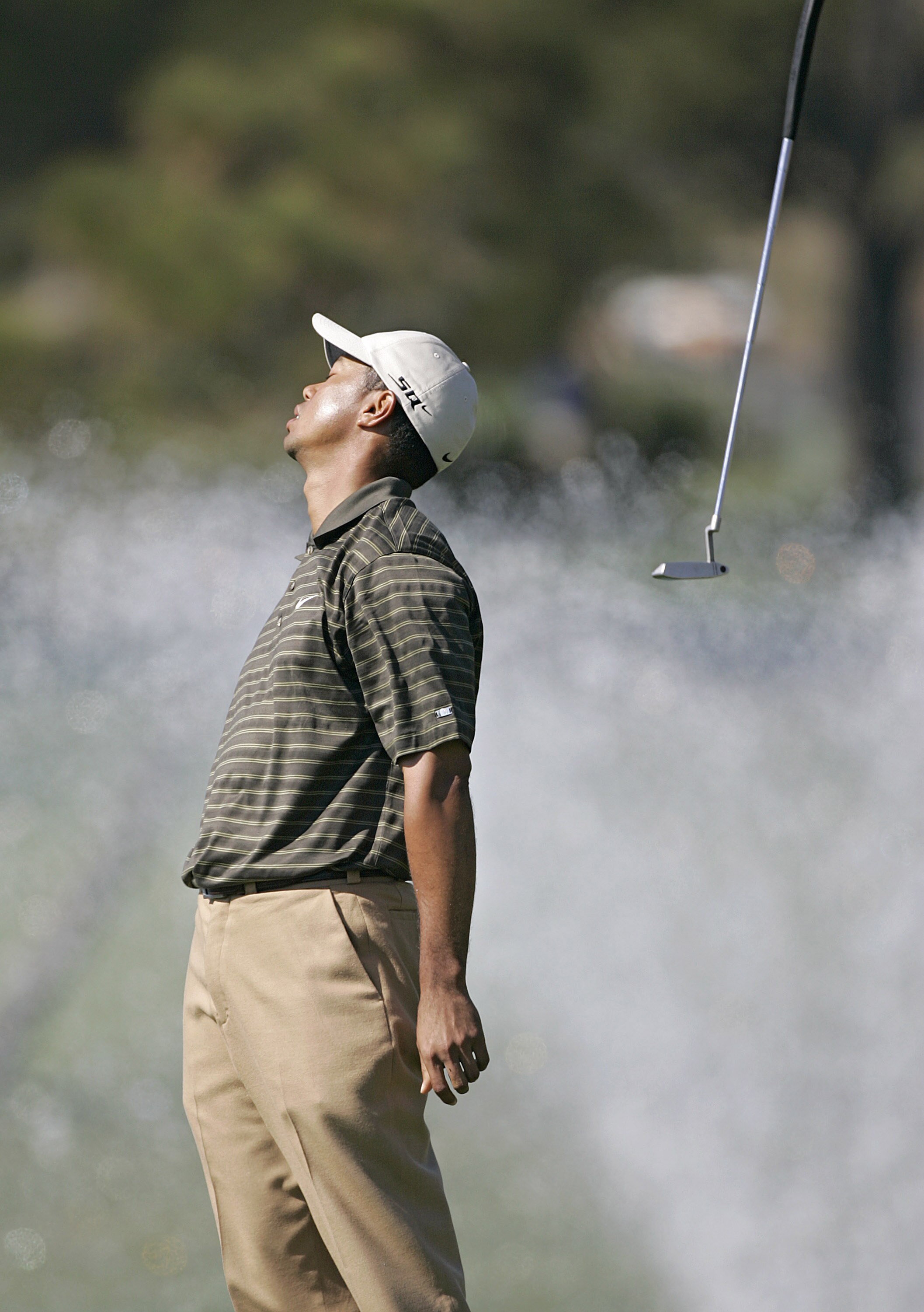 UNITED STATES - FEBRUARY 24:  Tiger Woods tosses his putter in disbelief after missing a putt on the 16th green during the third round of the WGC - Accenture Match Play Championship held at La Costa Resort and Spa in Carlsbad, California, on February 24, 