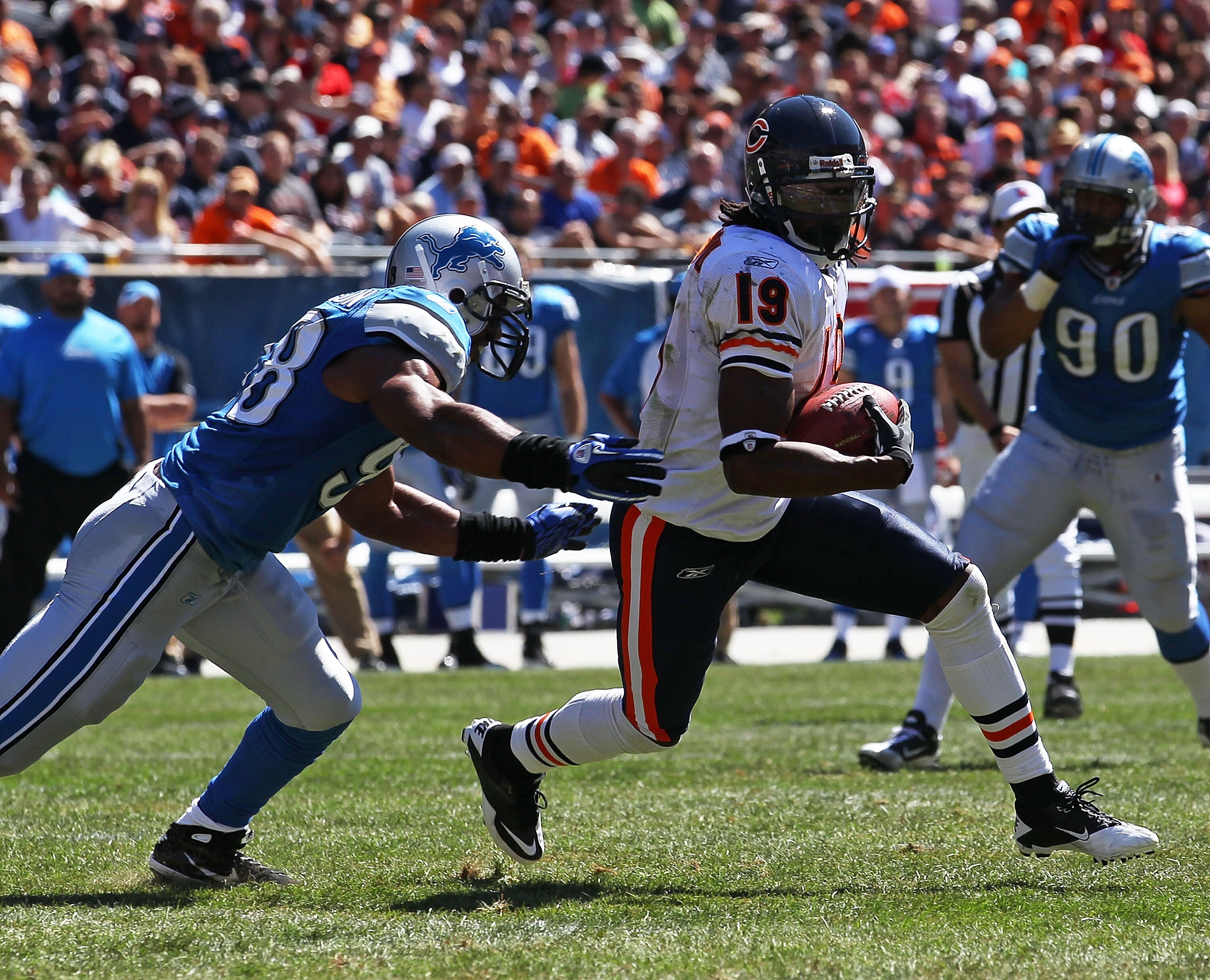 CHICAGO - SEPTEMBER 12: Devin Aromashodu #19 of the Chicago Bears is chased by Julian Peterson #98 of the Detroit Lions after a catch during the NFL season opening game at Soldier Field on September 12, 2010 in Chicago, Illinois. The Bears defeated the Li CHICAGO - SEPTEMBER 12: Devin Aromashodu #19 of the Chicago Bears is chased by Julian Peterson #98 of the Detroit Lions after a catch during the NFL season opening game at Soldier Field on September 12, 2010 in Chicago, Illinois. The Bears defeated the Li