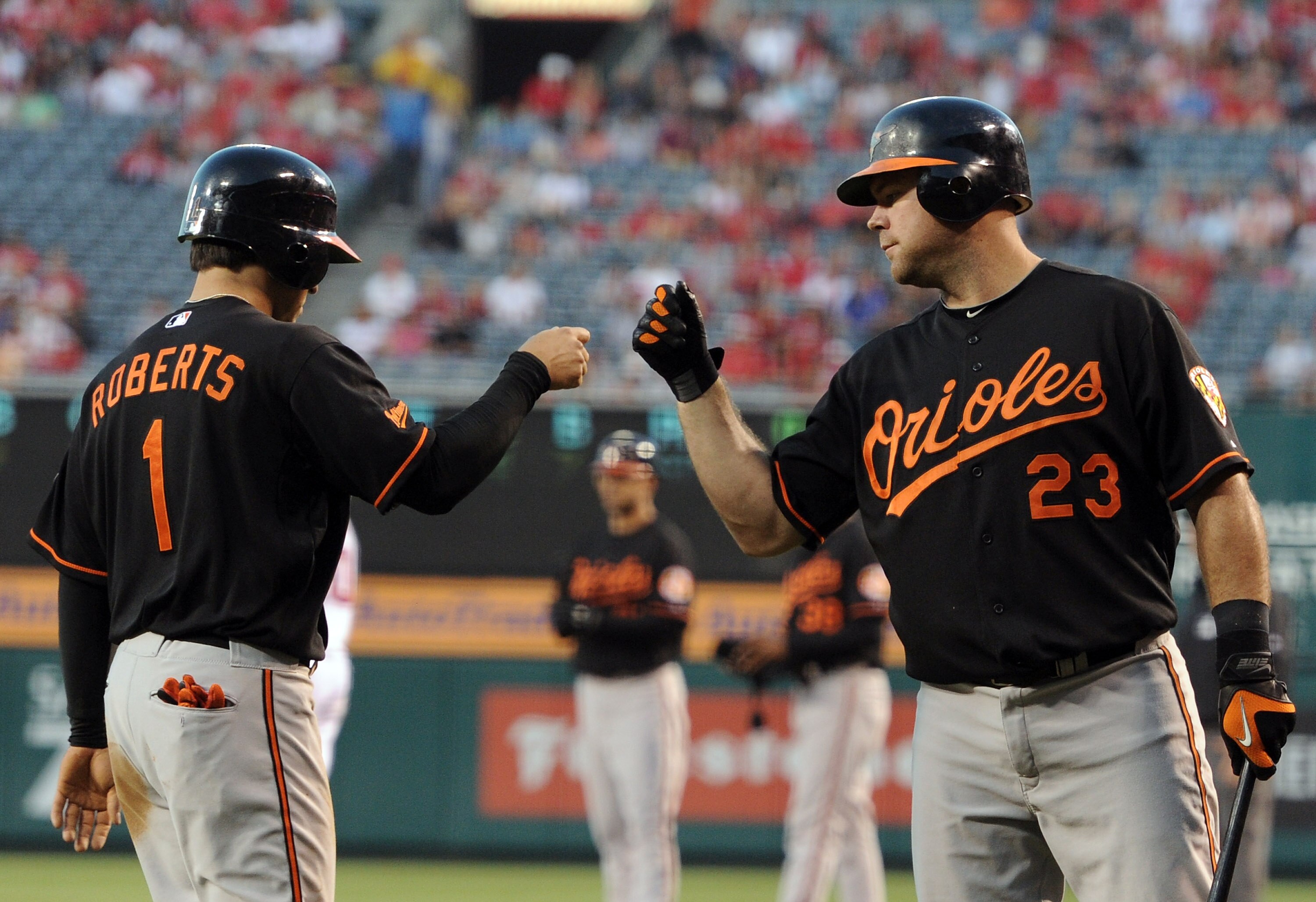 ANAHEIM, CA - AUGUST 27:  Brian Roberts #1 celebrates his run with Ty Wigginton #23 of  Baltimore Orioles for a 1-0 lead over the Los Angeles Angels of Anaheim on August 27, 2010 in Anaheim, California.  (Photo by Harry How/Getty Images)