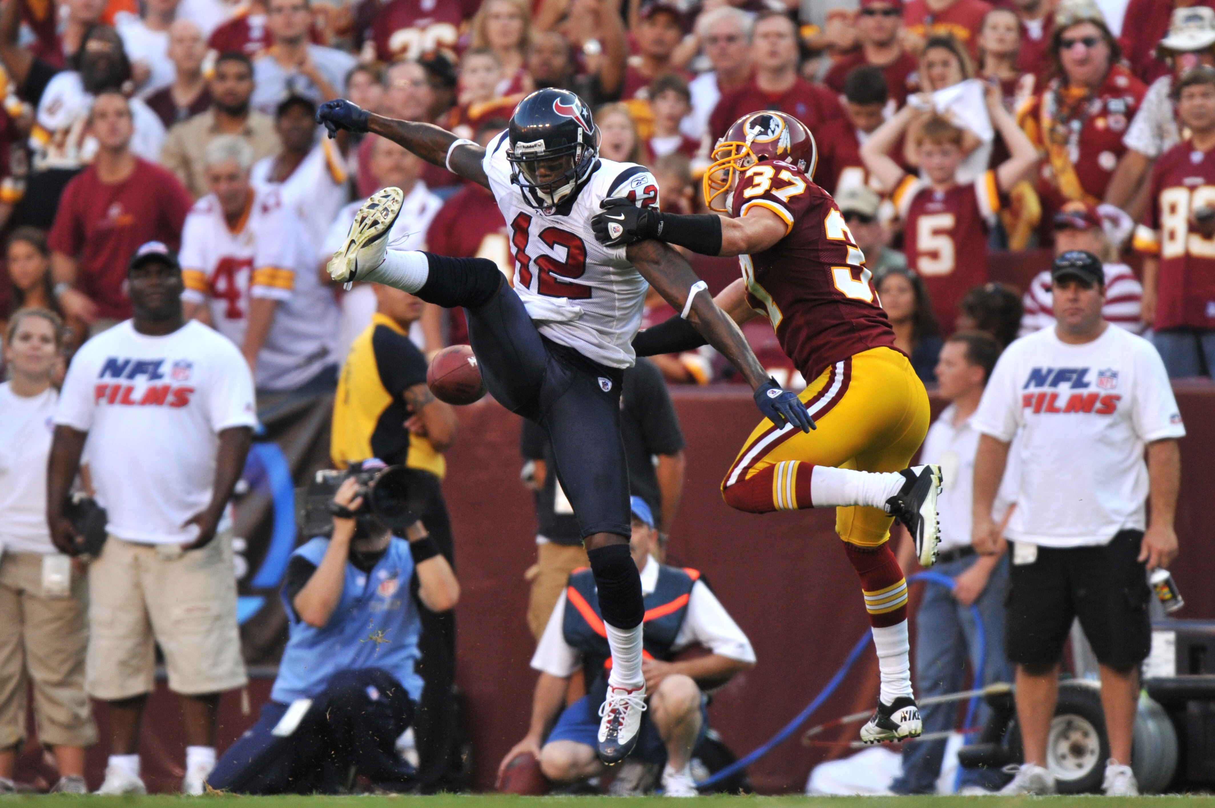 LANDOVER - SEPTEMBER 19: Jacoby Jones #12 of the Houston Texans can't hold onto a pass defended by Reed Doughty #37 of the Washington Redskins at FedExField on September 19, 2010 in Landover, Maryland. The Texans defeated the Redskins 30-27 in overtime. LANDOVER - SEPTEMBER 19: Jacoby Jones #12 of the Houston Texans can't hold onto a pass defended by Reed Doughty #37 of the Washington Redskins at FedExField on September 19, 2010 in Landover, Maryland. The Texans defeated the Redskins 30-27 in overtime.