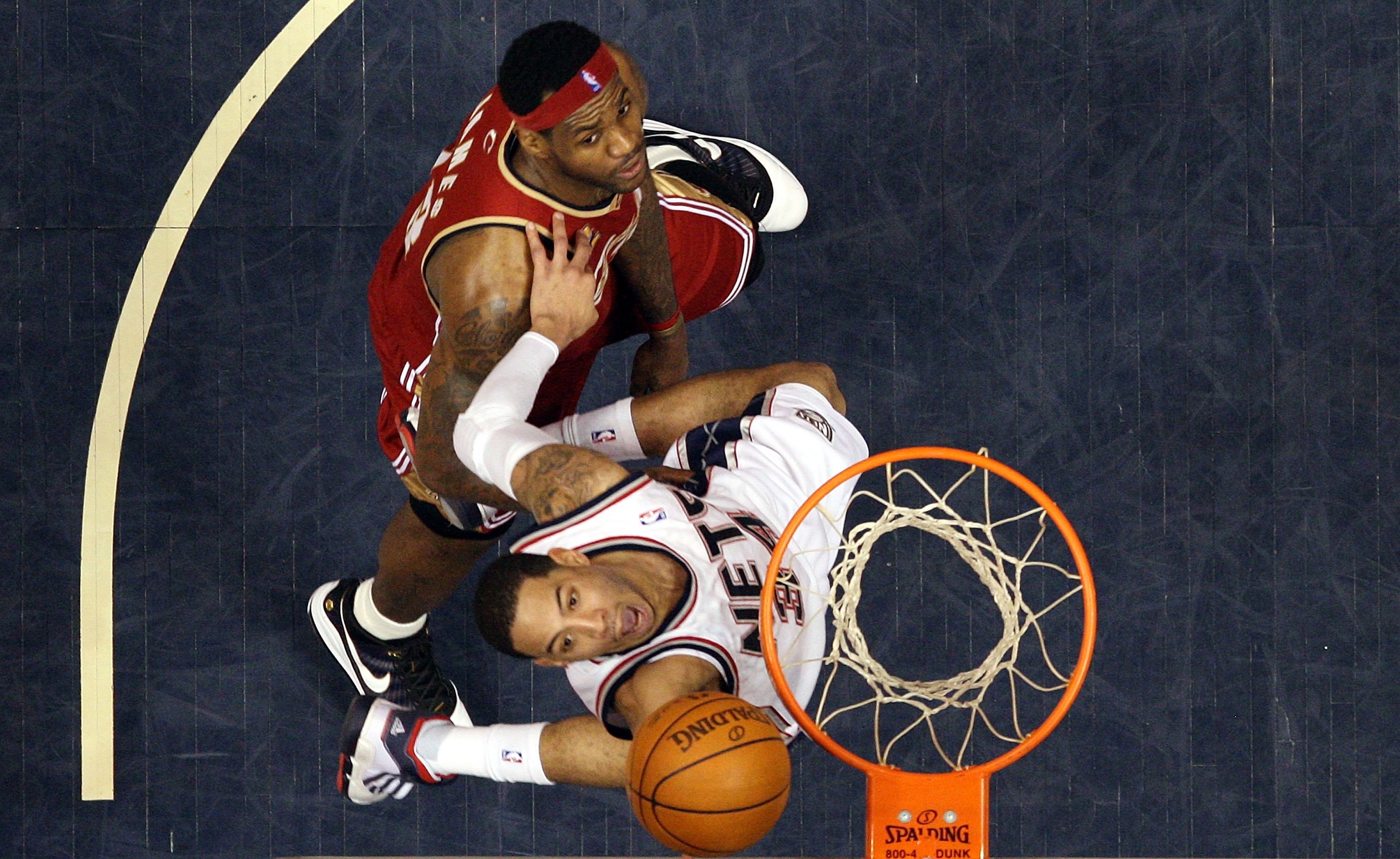 EAST RUTHERFORD, NJ - MARCH 03:  Devin Harris #34 of the New Jersey Nets goes to the hoop against LeBron James #23 of the Cleveland Cavaliers at the Izod Center on March 3, 2010 in East Rutherford, New Jersey.NOTE TO USER: User expressly acknowledges and 