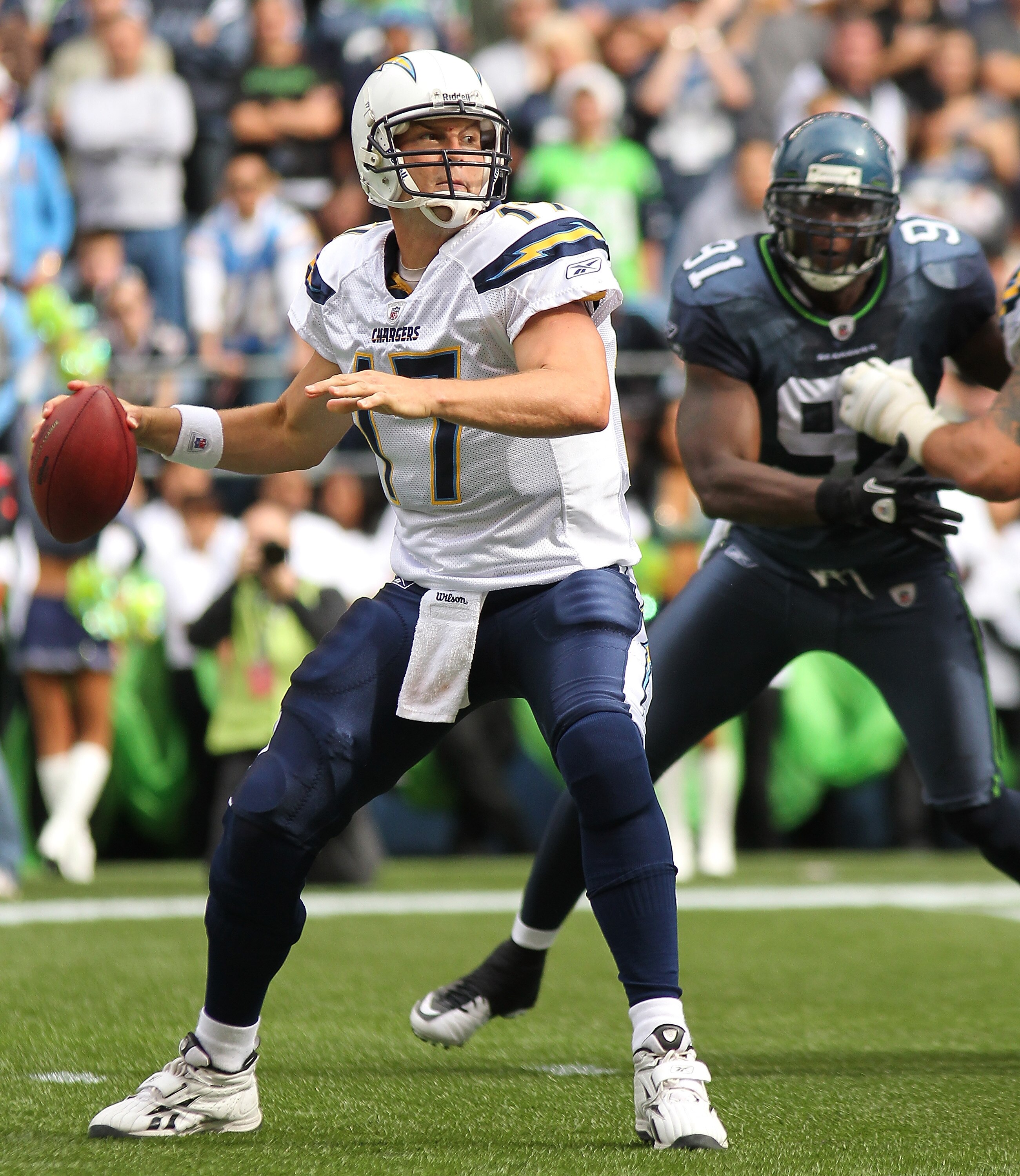 SEATTLE - SEPTEMBER 26:  Quarterback Philip Rivers #17 of the San Diego Chargers passes under pressure from Chris Clemons #91 of the Seattle Seahawks at Qwest Field on September 26, 2010 in Seattle, Washington. The Seahawks defeated the Chargers 27-20.(Ph