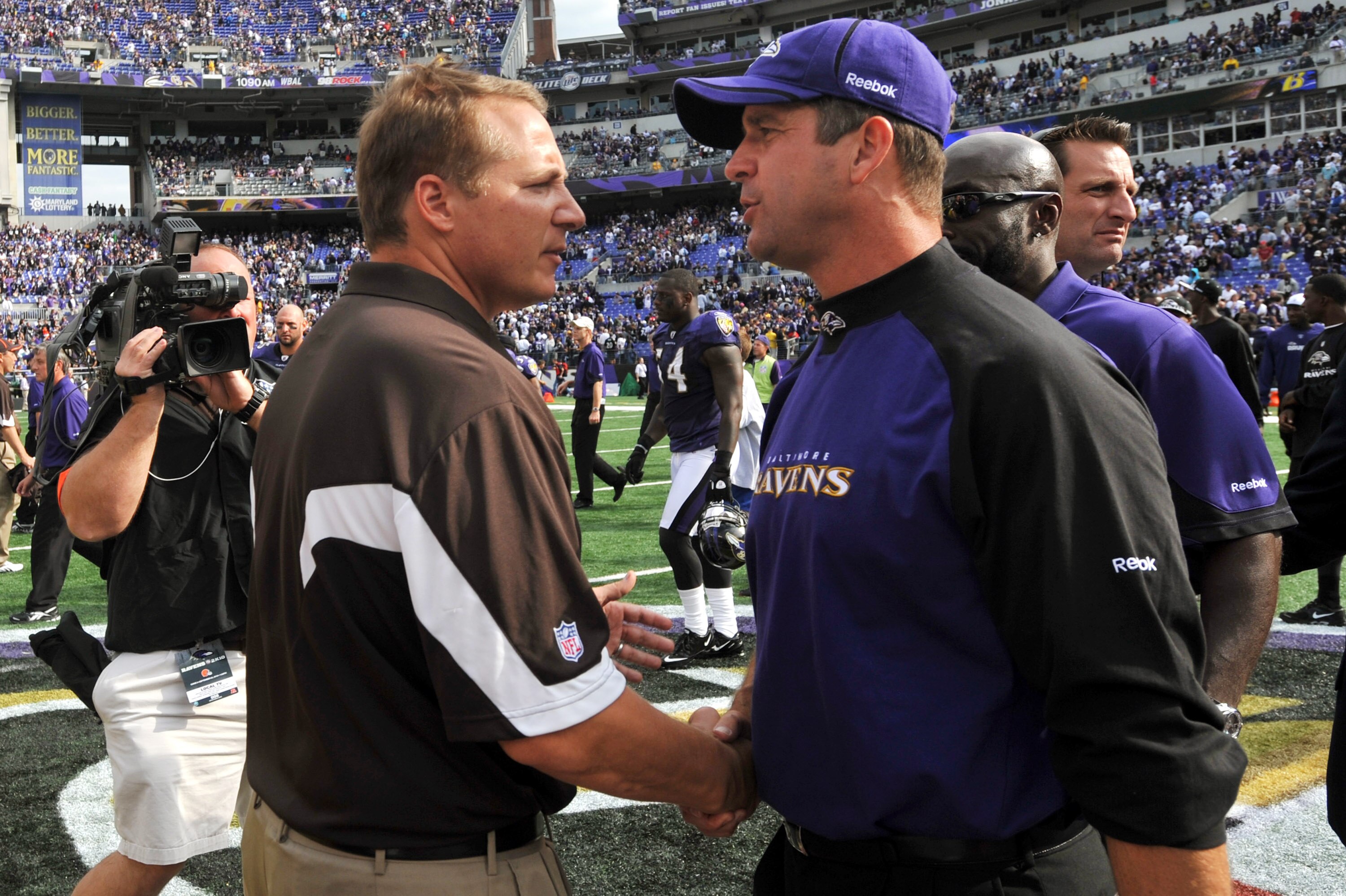 BALTIMORE - SEPTEMBER 26:  Head coach John Harbaugh of the Baltimore Ravens shakes hands after the game with head coach Eric Mangini of the Cleveland Browns  at M&T Bank Stadium on September 26, 2010 in Baltimore, Maryland. The Ravens defeated the Browns