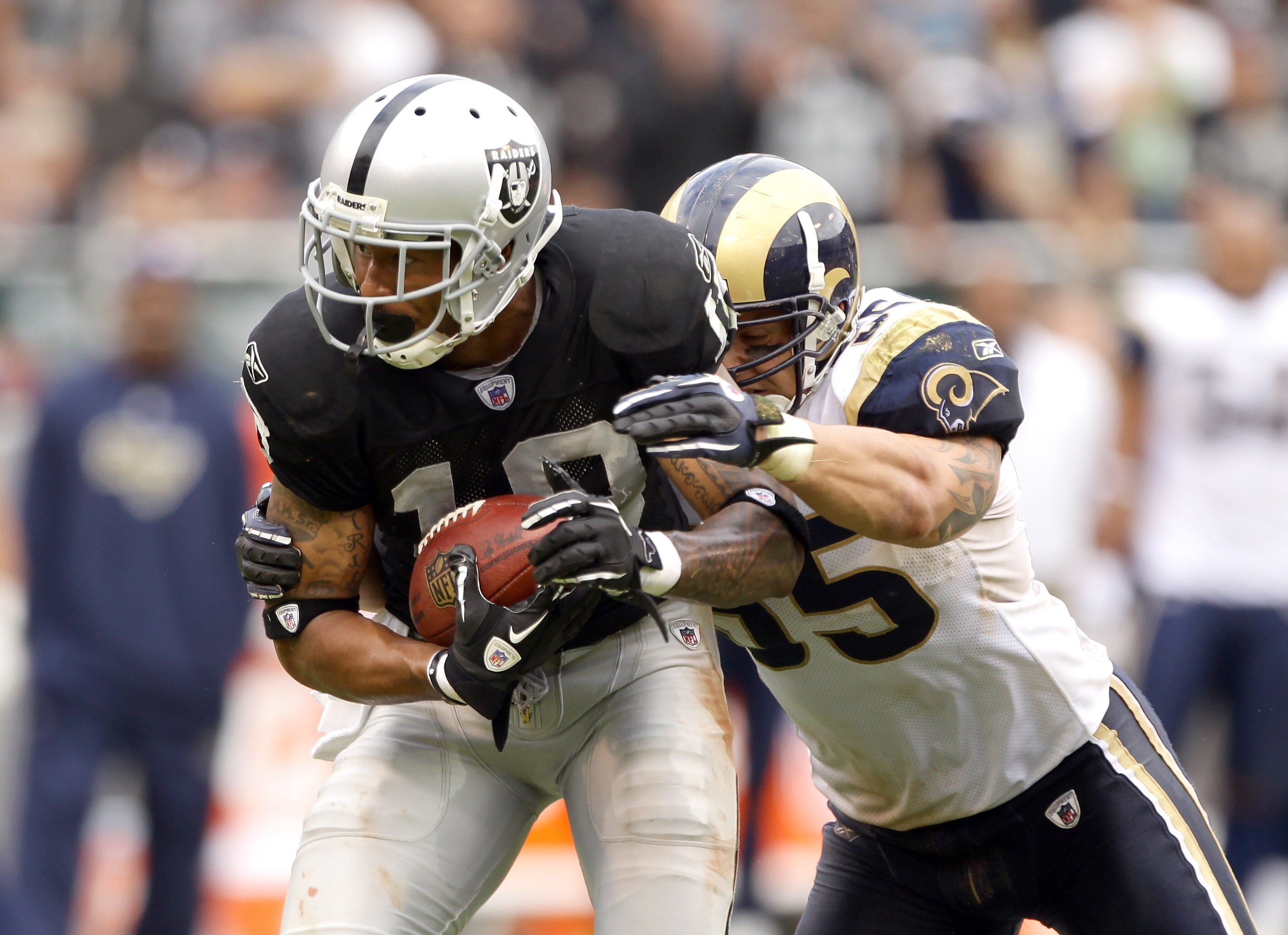 OAKLAND, CA - SEPTEMBER 19:  James Laurinaitis #55 of the St. Louis Rams tackles Louis Murphy #18 of the Oakland Raiders at the Oakland-Alameda County Coliseum on September 19, 2010 in Oakland, California.  (Photo by Ezra Shaw/Getty Images)