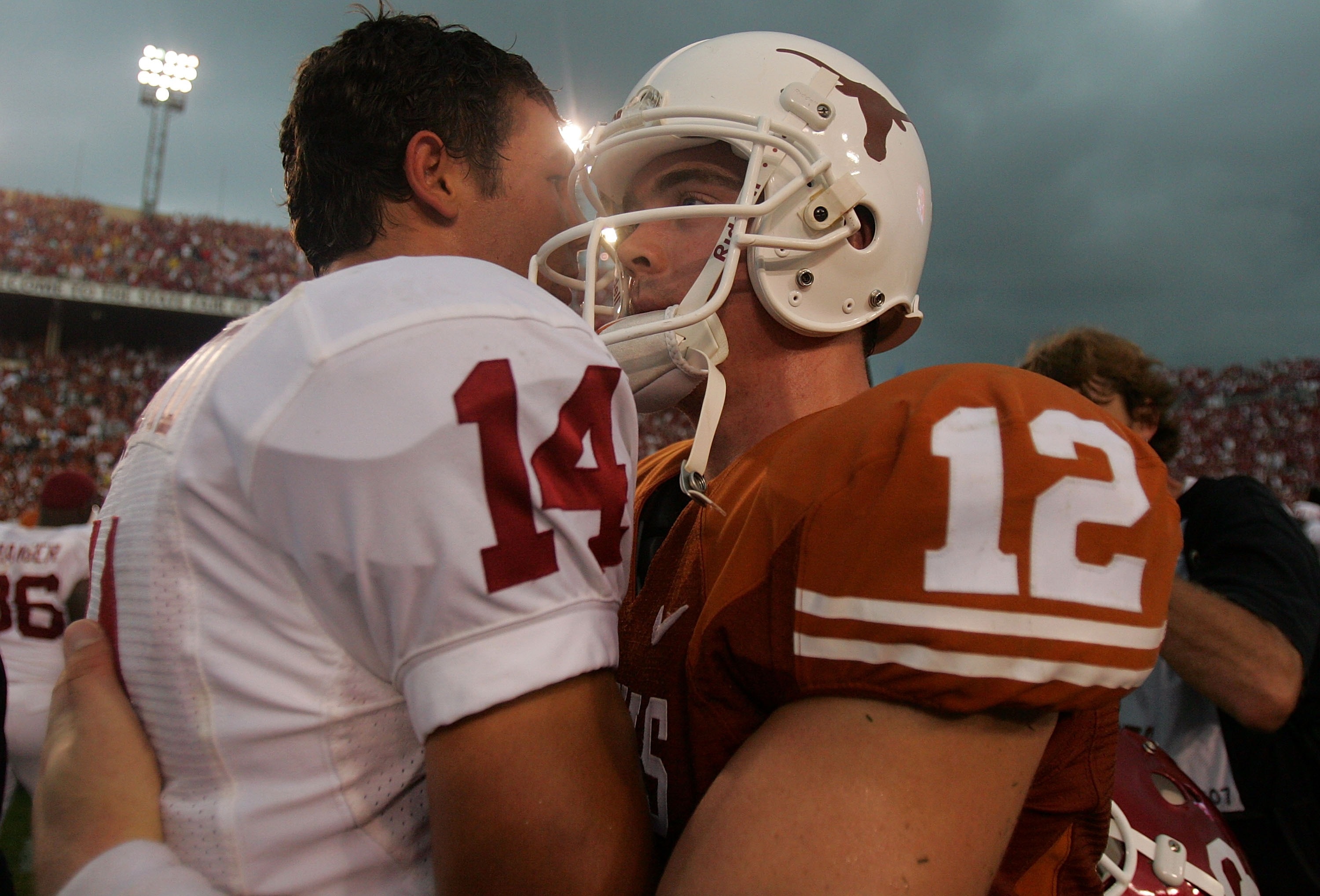 DALLAS - OCTOBER 6:  Quarterback Sam Bradford #14 of the Oklahoma Sooners and Colt McCoy of the Texas Longhorns embrace after the Sooners defeated the Longhorns 28-21 at the Cotton Bowl October 6, 2007 in Dallas, Texas.  (Photo by Ronald Martinez/Getty Im