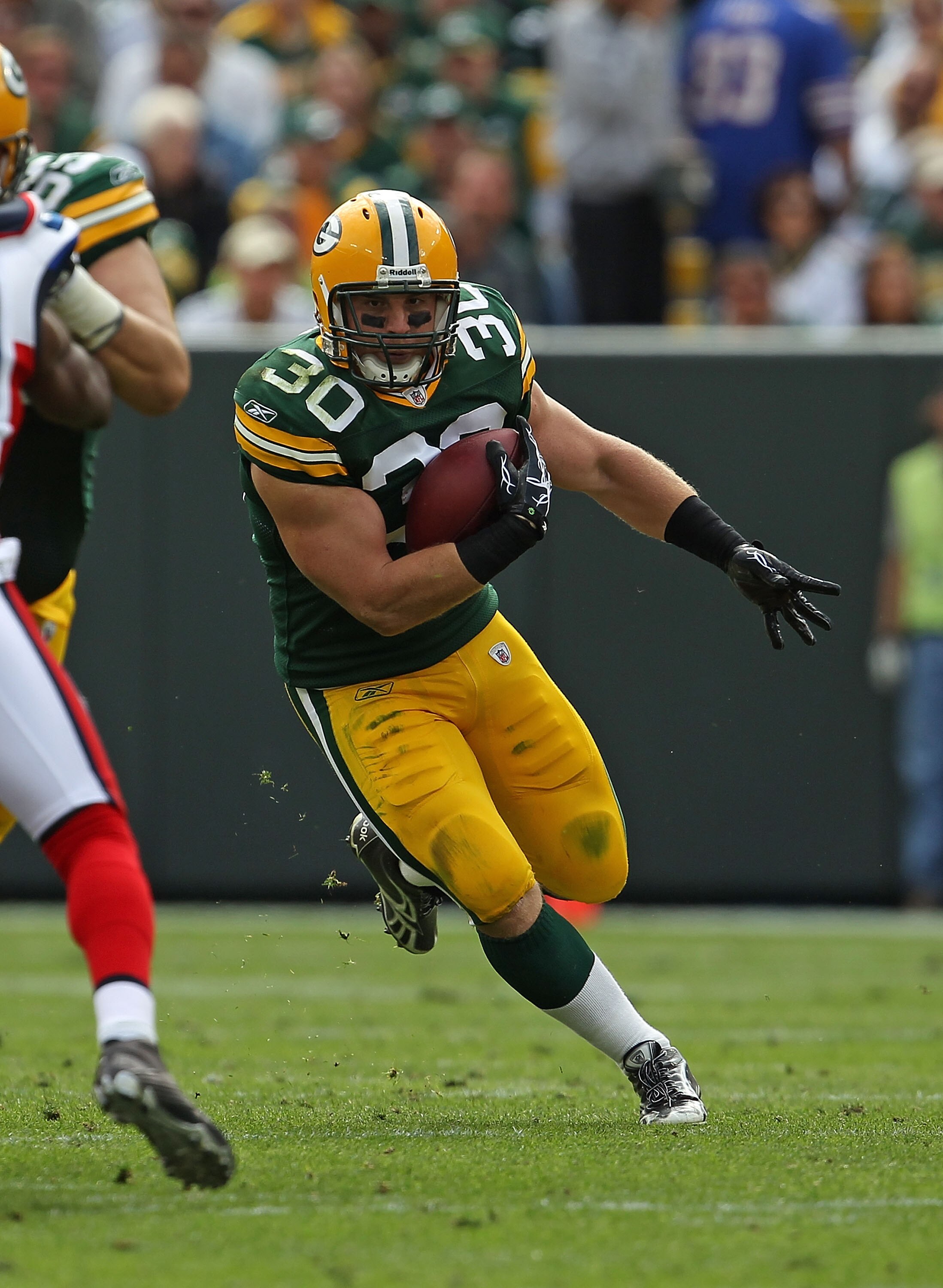 GREEN BAY, WI - SEPTEMBER 19: John Kuhn #30 of the Green Bay Packers runs against the Buffalo Bills at Lambeau Field on September 19, 2010 in Green Bay, Wisconsin. The Packers defeated the Bills 34-7.  (Photo by Jonathan Daniel/Getty Images)