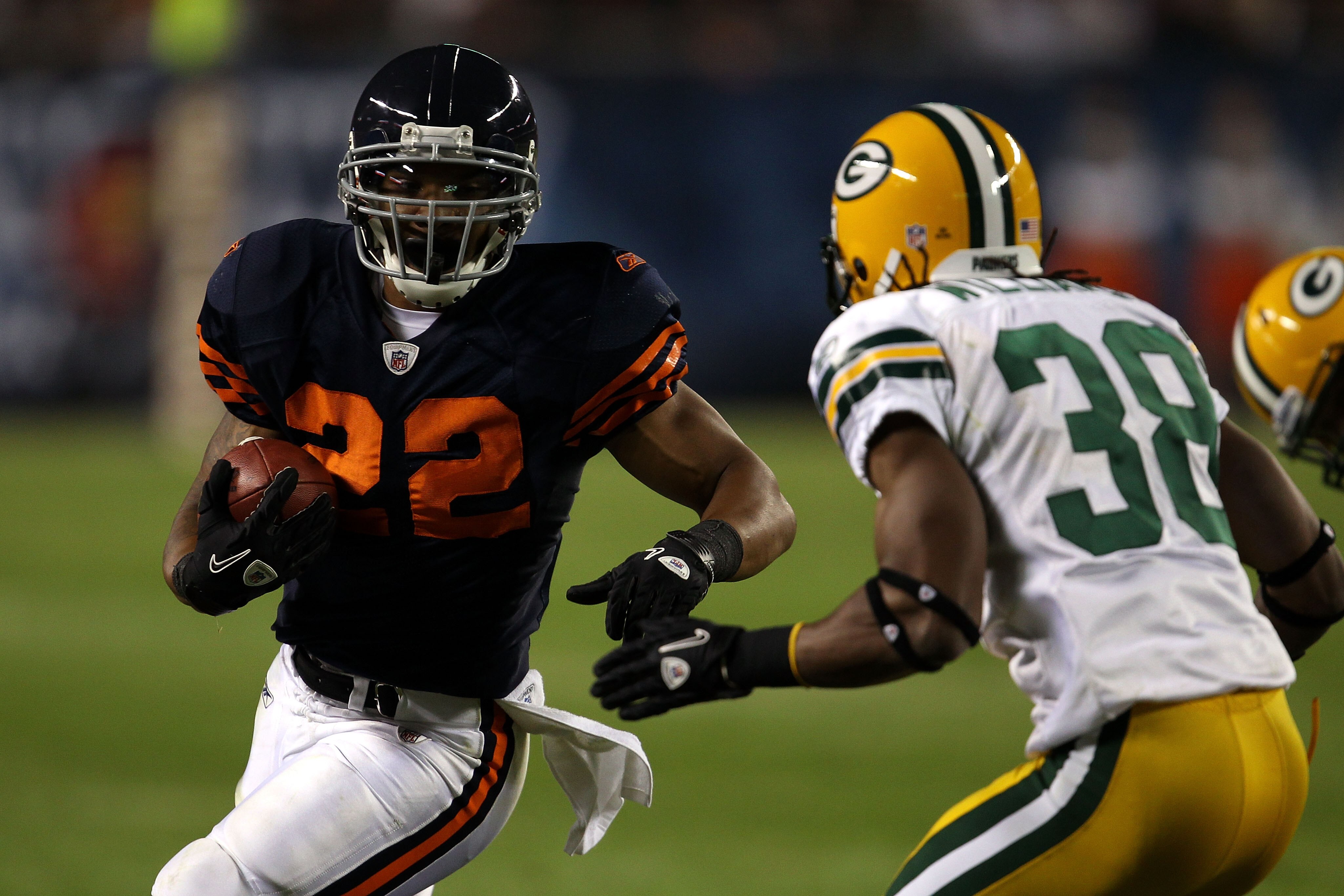 CHICAGO - SEPTEMBER 27:  Matt Forte #22 of the Chicago Bears runs the ball against Tramon Williams #38 of the Green Bay Packers at Soldier Field on September 27, 2010 in Chicago, Illinois.  (Photo by Jonathan Daniel/Getty Images)