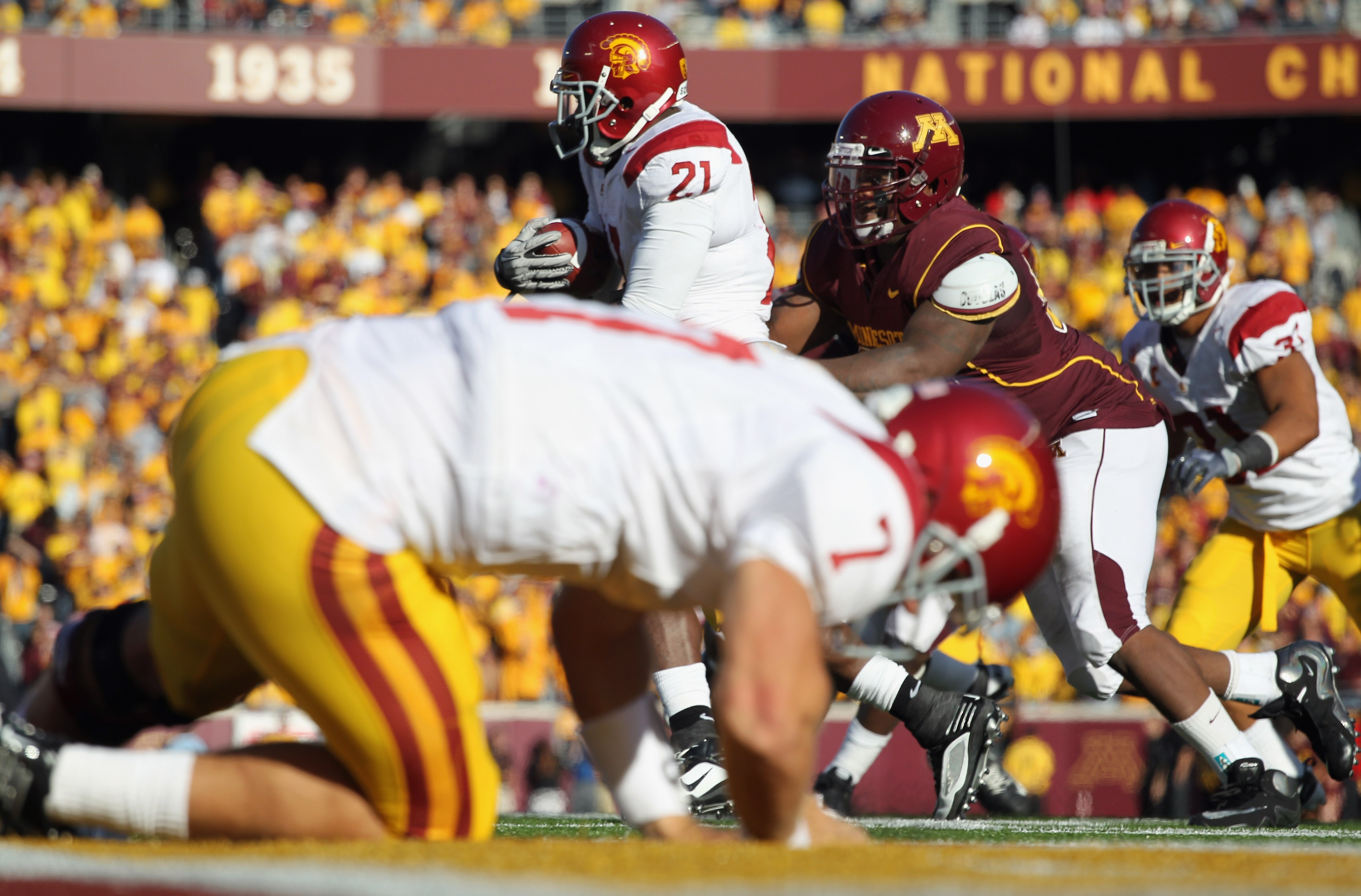 MINNEAPOLIS - SEPTEMBER 18:  Quarterback Matt Barkley #7 of the USC Trojans falls to the ground after handing off to Allan Bradford #21 during the game against the Minnesota Golden Gophers on September 18, 2010 at TCF Bank Stadium in Minneapolis, Minnesot