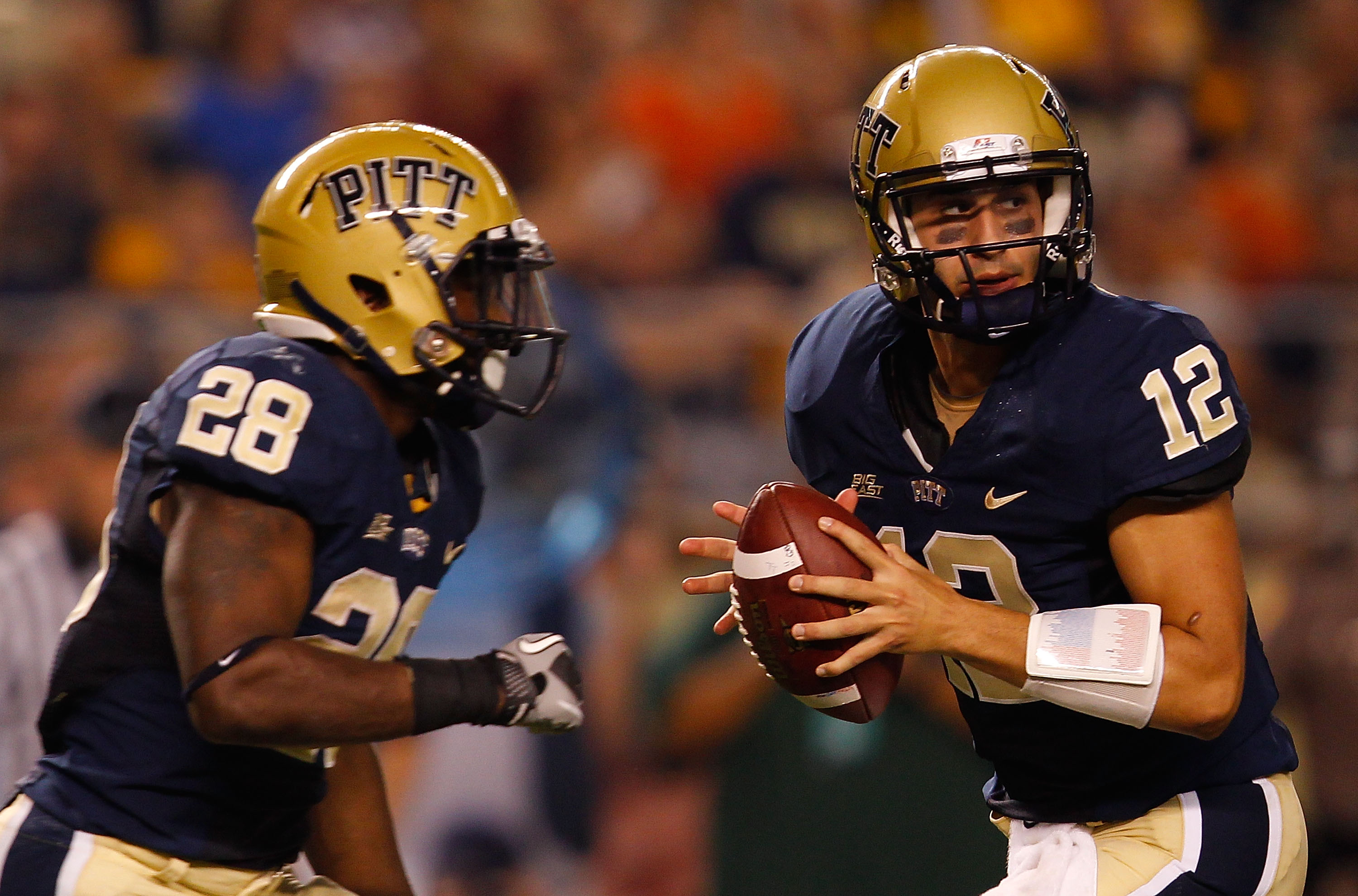 PITTSBURGH - SEPTEMBER 23:  Tino Sunseri #12 of the Pittsburgh Panthers drops back to pass in front of teammate Dion Lewis #28 during the game against the Miami Hurricanes on September 23, 2010 at Heinz Field in Pittsburgh, Pennsylvania.  (Photo by Jared 