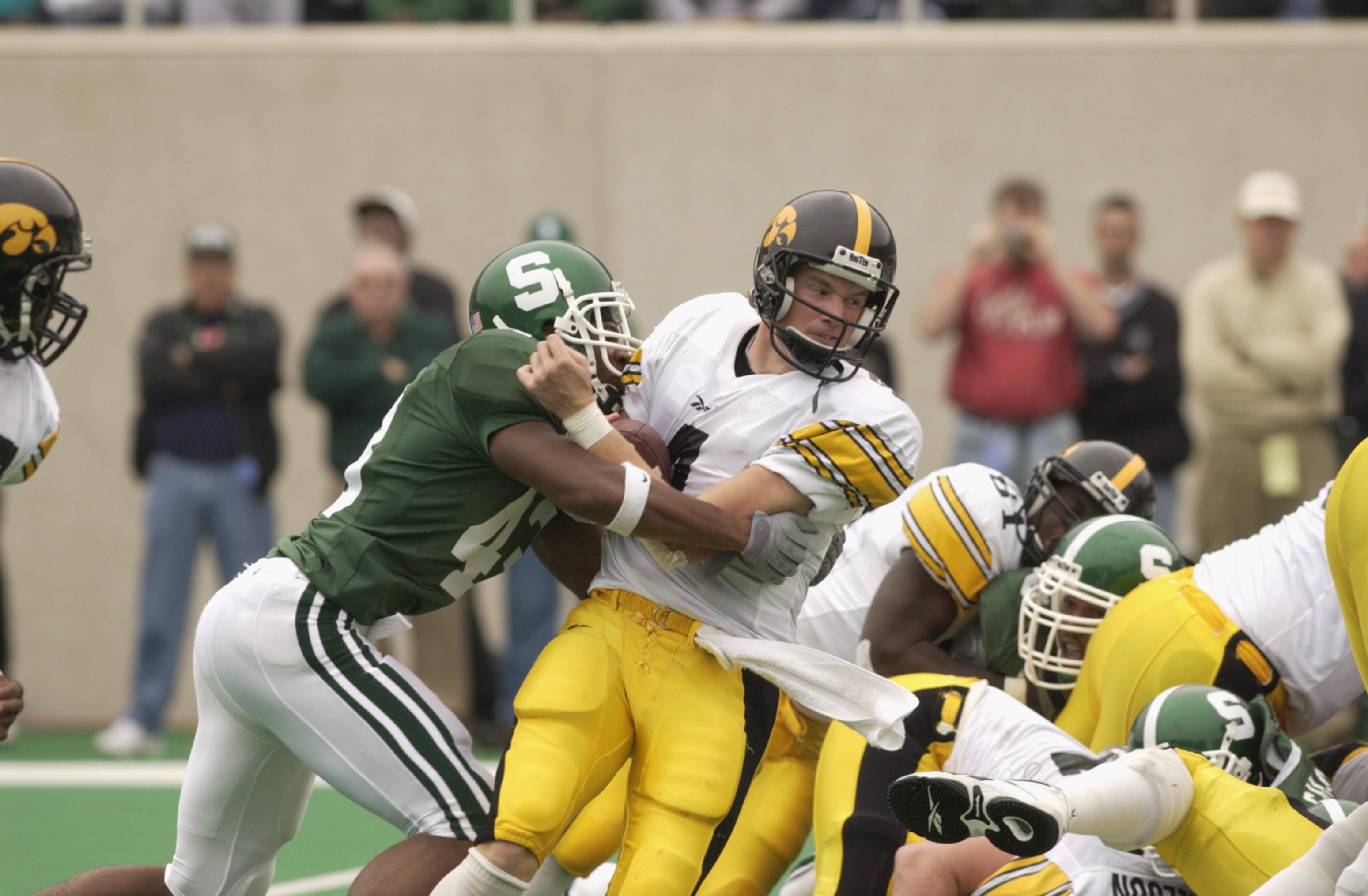 EAST LANSING, MI - OCTOBER 13:  Safety Thomas Wright #43 of the Michigan State Spartans sacks quarterback Kyle McCann #4 of the Iowa Hawkeyes during the Big Ten Conference football game on October 13, 2001 at Spartan Stadium in East Lansing, Michigan. The