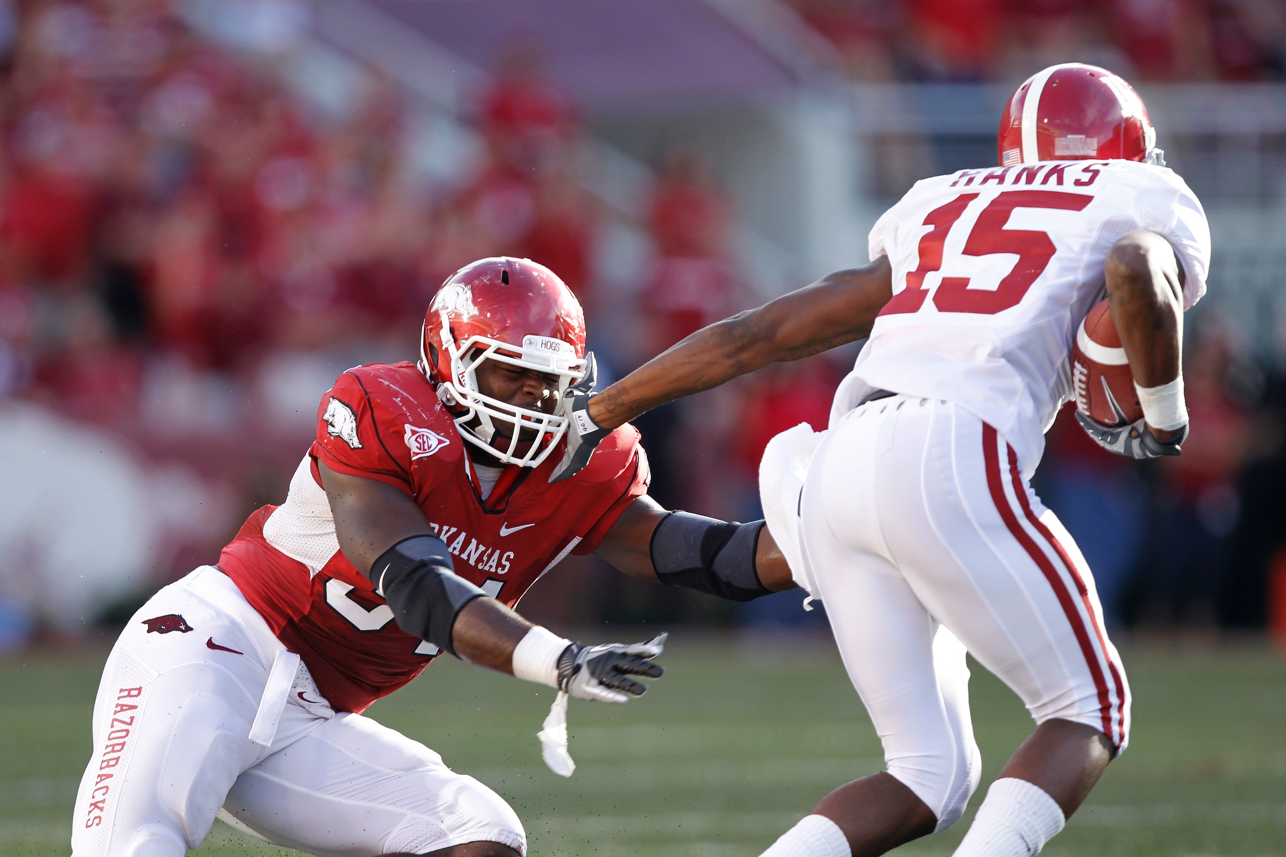 FAYETTEVILLE - SEPTEMBER 25: Darius Hanks #15 of the Alabama Crimson Tide tries to get around a tackle attempt by Jerry Franklin #34 of the Arkansas Razorbacks at Donald W. Reynolds Razorback Stadium on September 25, 2010 in Fayetteville, Arkansas. Alabam