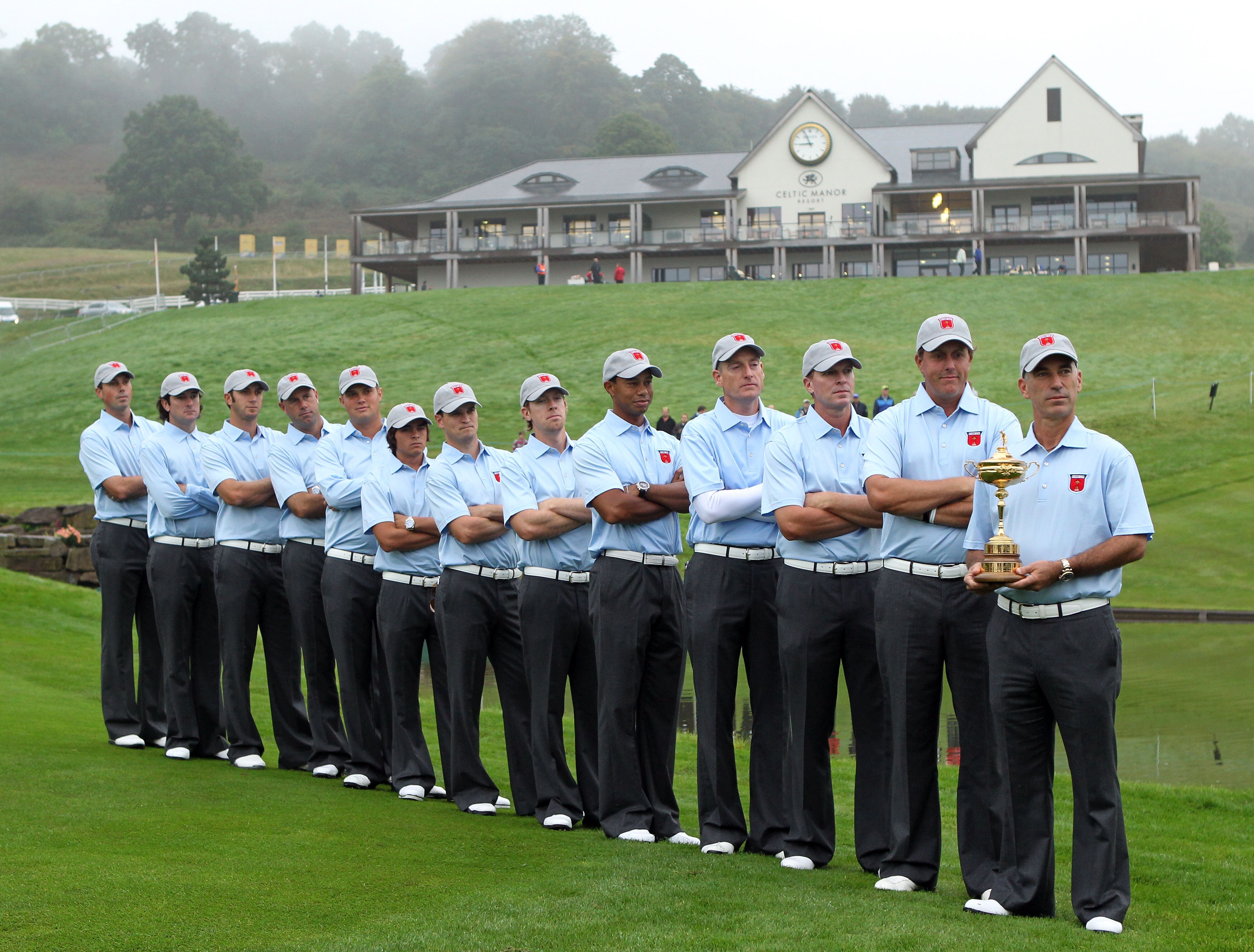 NEWPORT, WALES - SEPTEMBER 28:  (L-R)  Matt Kuchar, Bubba Watson, Dustin Johnson, Stewart Cink, Jeff Overton, Rickie Fowler, Zach Johnson, Hunter Mahan, Tiger Woods, Jim Furyk, Steve Stricker, Phil Mickelson and Team Captain Corey Pavin pose with the trop