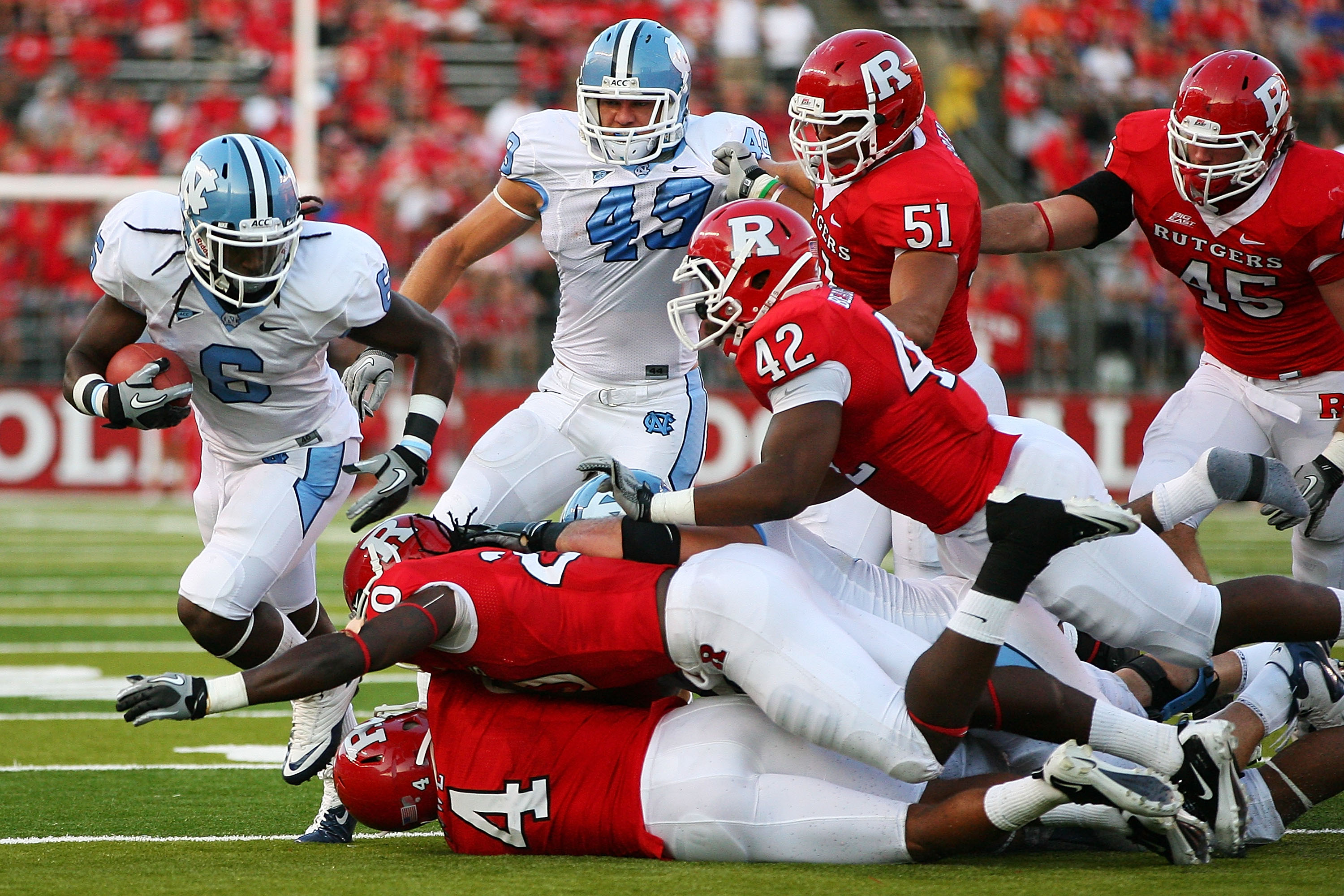 NEW BRUNSWICK, NJ - SEPTEMBER 25:  Anthony Elzy #6 (L) of the North Carolina Tar Heels breaks runs past the Rutgers Scarlet Knights defense during the third quarter at Rutgers Stadium on September 25, 2010 in New Brunswick, New Jersey.  (Photo by Andrew B