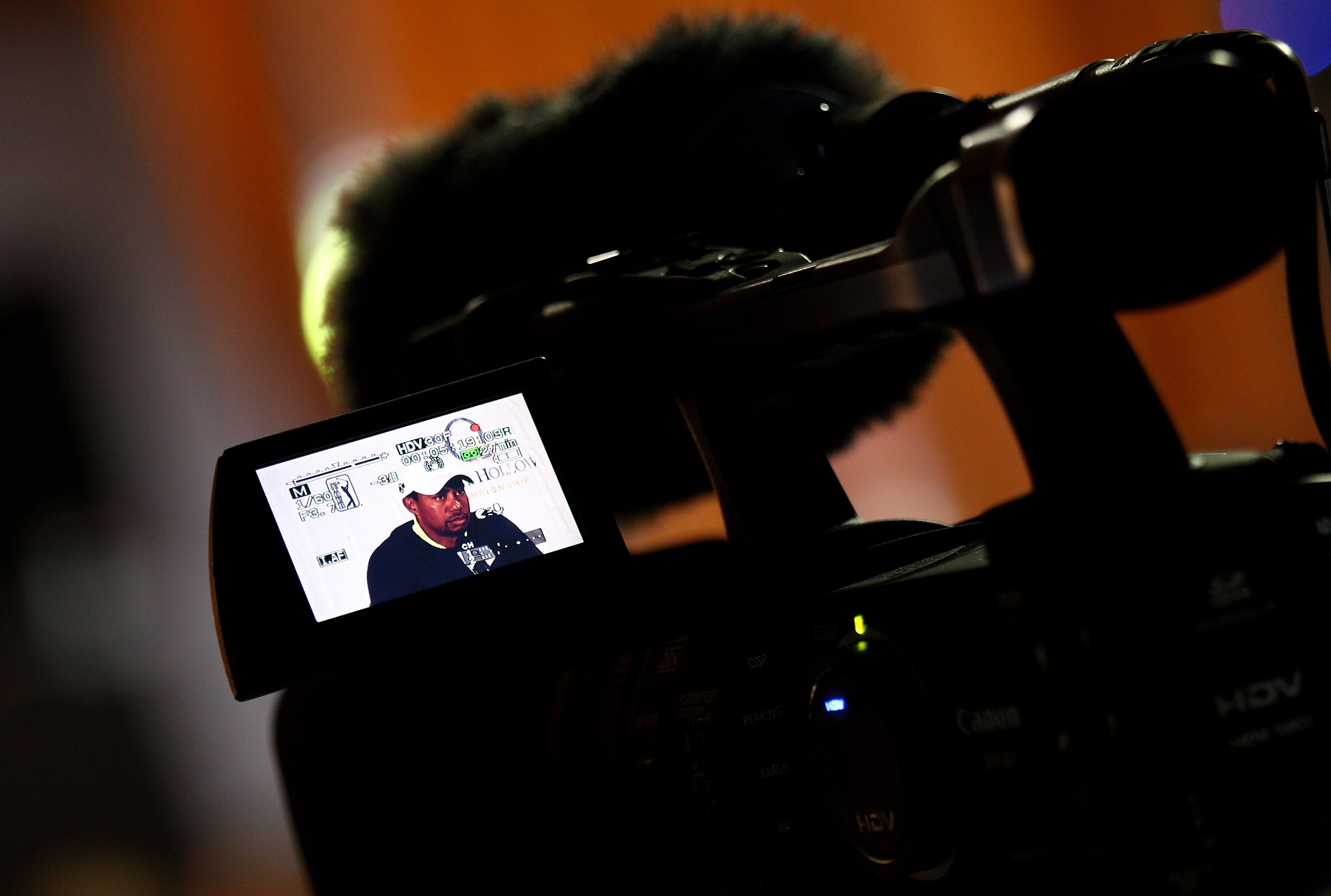 CHARLOTTE, NC - APRIL 28:  Tiger Woods is seen through the viewfinder of a TV camera as he speaks to the media in a press conference during the pro-am for the Quail Hollow Championship at Quail Hollow Country Club on April 28, 2010 in Charlotte, North Car