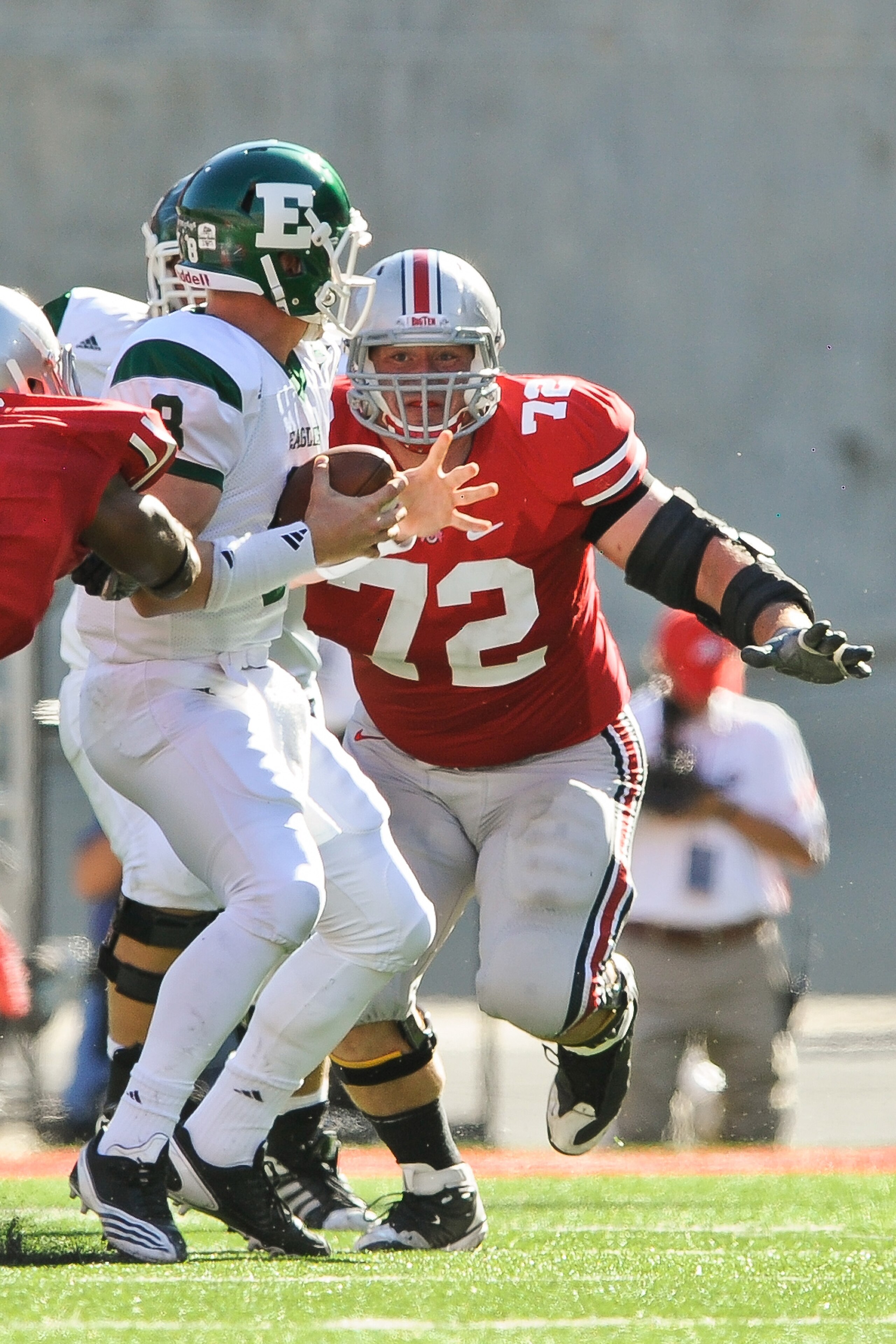 COLUMBUS, OH - SEPTEMBER 25:  Dexter Larimore #72 of the Ohio State Buckeyes chases down quarterback Alex Gillett  #8 of the Eastern Michigan Eagles at Ohio Stadium on September 25, 2010 in Columbus, Ohio.  Ohio State won 73-20. (Photo by Jamie Sabau/Gett
