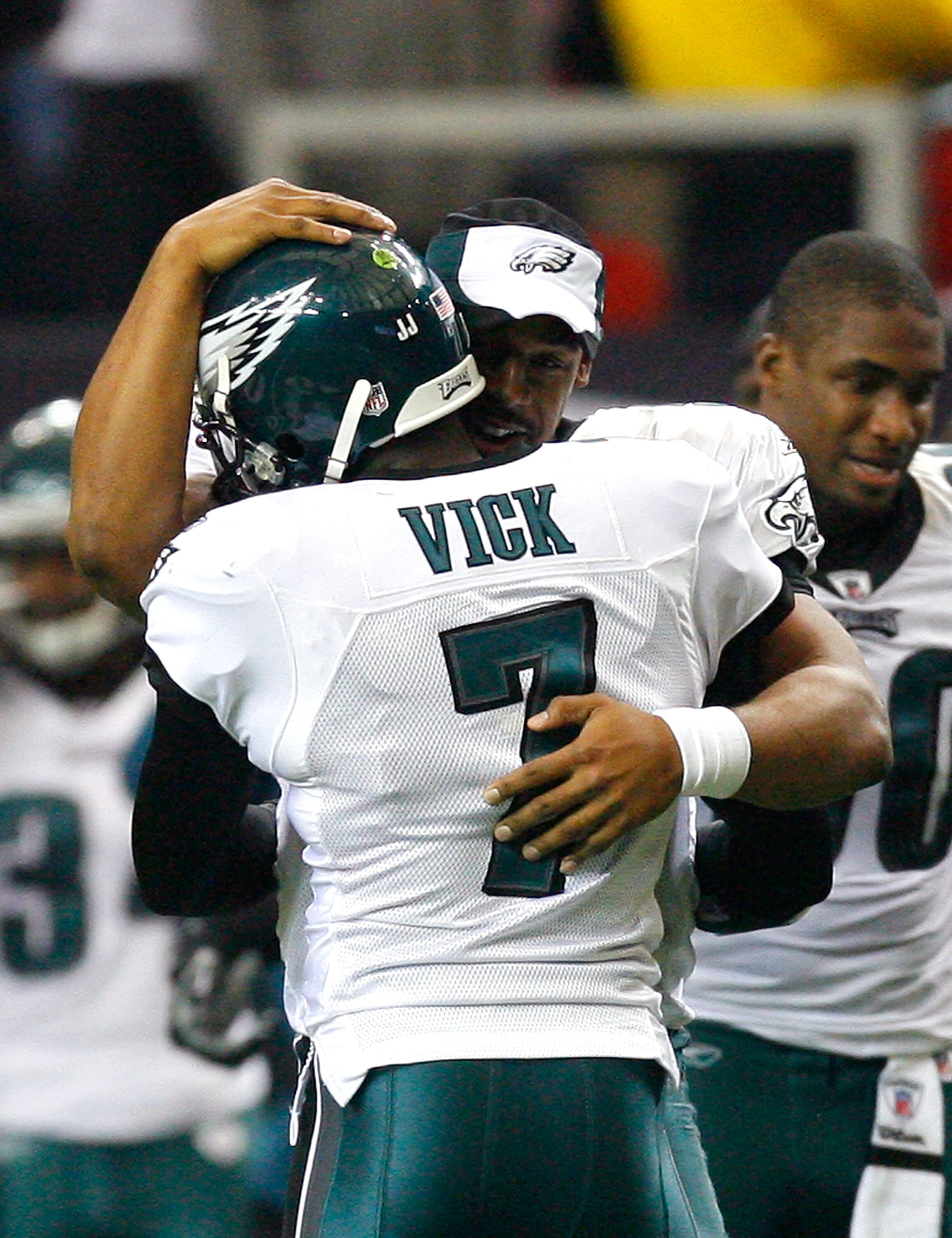 ATLANTA - DECEMBER 06:  Donovan McNabb #5 of the Philadelphia Eagles congratulates Michael Vick #7 after Vick passed for his second touchdown against the Atlanta Falcons at Georgia Dome on December 6, 2009 in Atlanta, Georgia.  (Photo by Kevin C. Cox/Gett