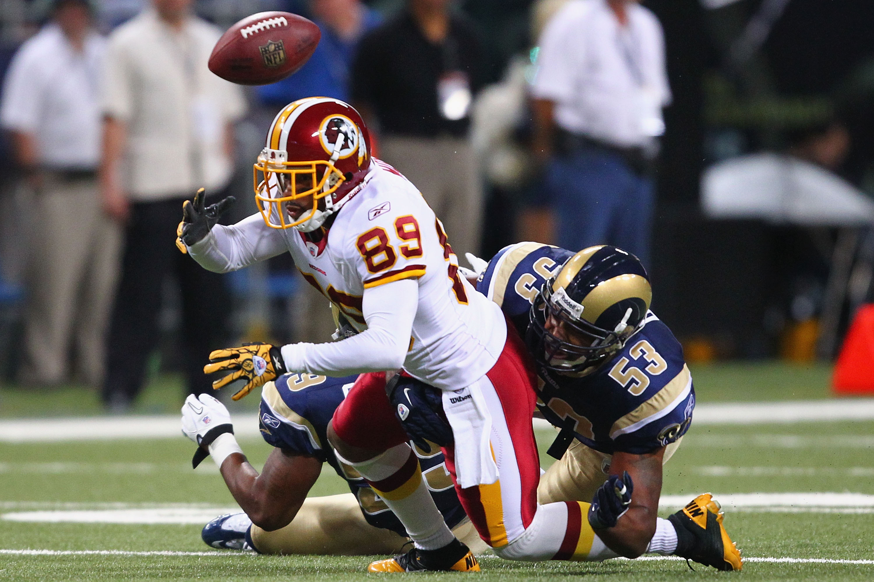 ST. LOUIS - SEPTEMBER 26: Na'Il Diggs #53 of the St. Louis Rams forces a fumble against Santana Moss #89 of the Washington Redskins at the Edward Jones Dome on September 26, 2010 in St. Louis, Missouri.  The Rams beat the Redskins 30-16.  (Photo by Dilip