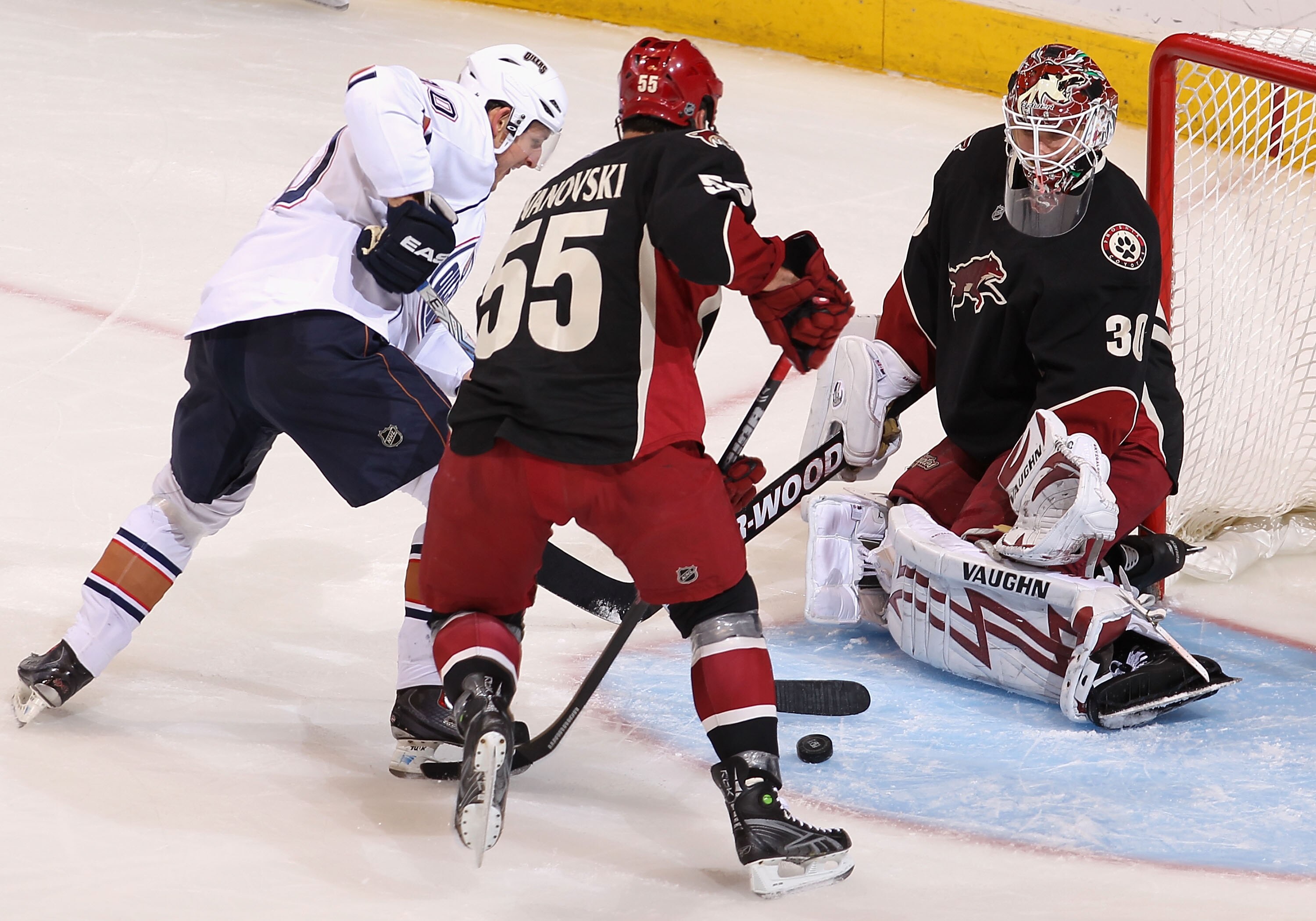 GLENDALE, AZ - APRIL 03:  Goaltender Ilya Bryzgalov #30 of the Phoenix Coyotes protects the net as Shawn Horcoff #10 of the Edmonton Oilers skates in with the puck during the second period of the NHL game at Jobing.com Arena on April 3, 2010 in Glendale,