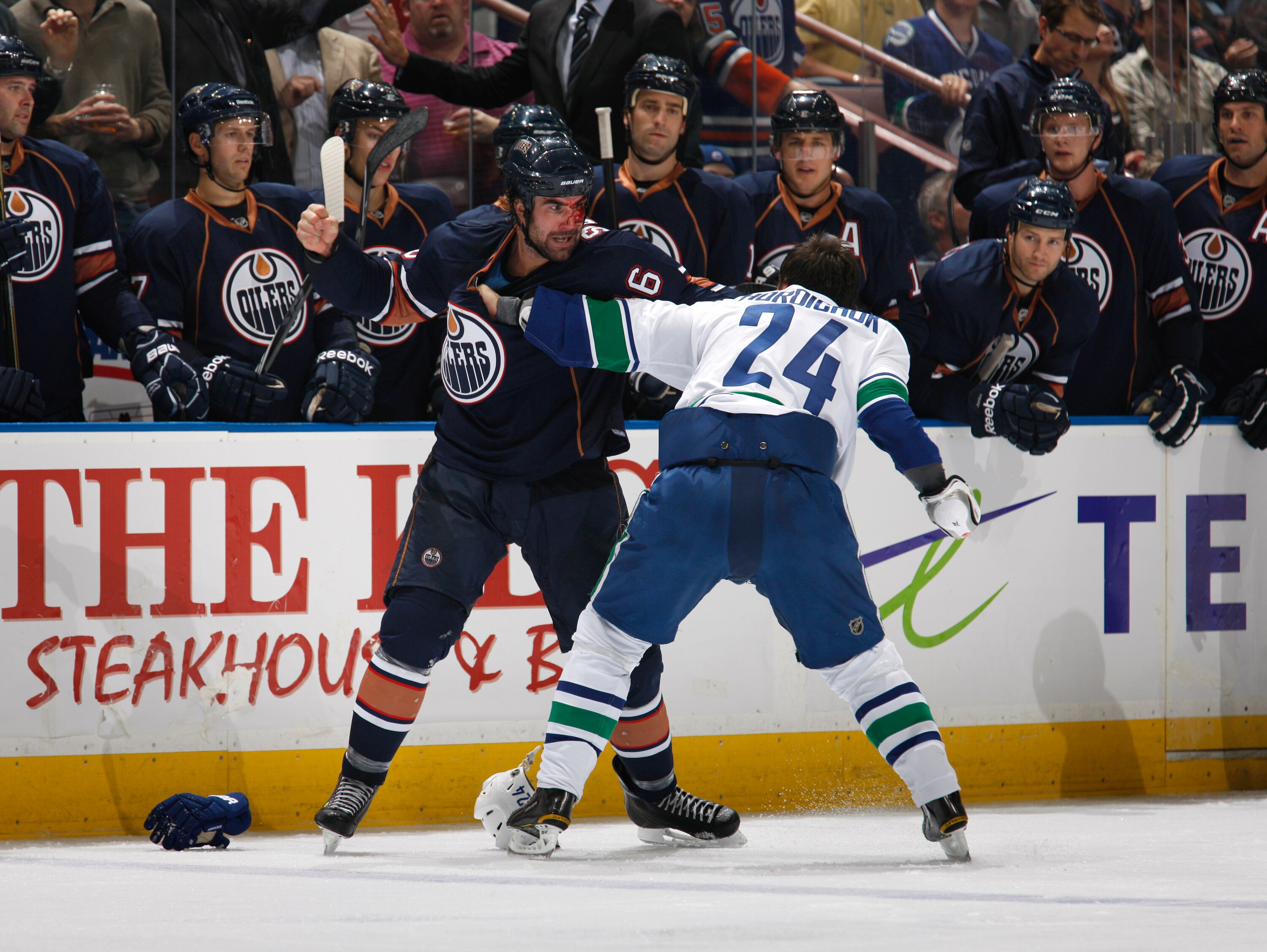 SEPTEMBER 26:   Zack Stortini #46 of the Edmonton Oilers exchanges punches with Darcy Hordichuk #24 of the Vancouver Canucks on September 26, 2010 at Rexall Place in Edmonton, Alberta, Canada. (Photo by Dale MacMillan/Getty Images)
