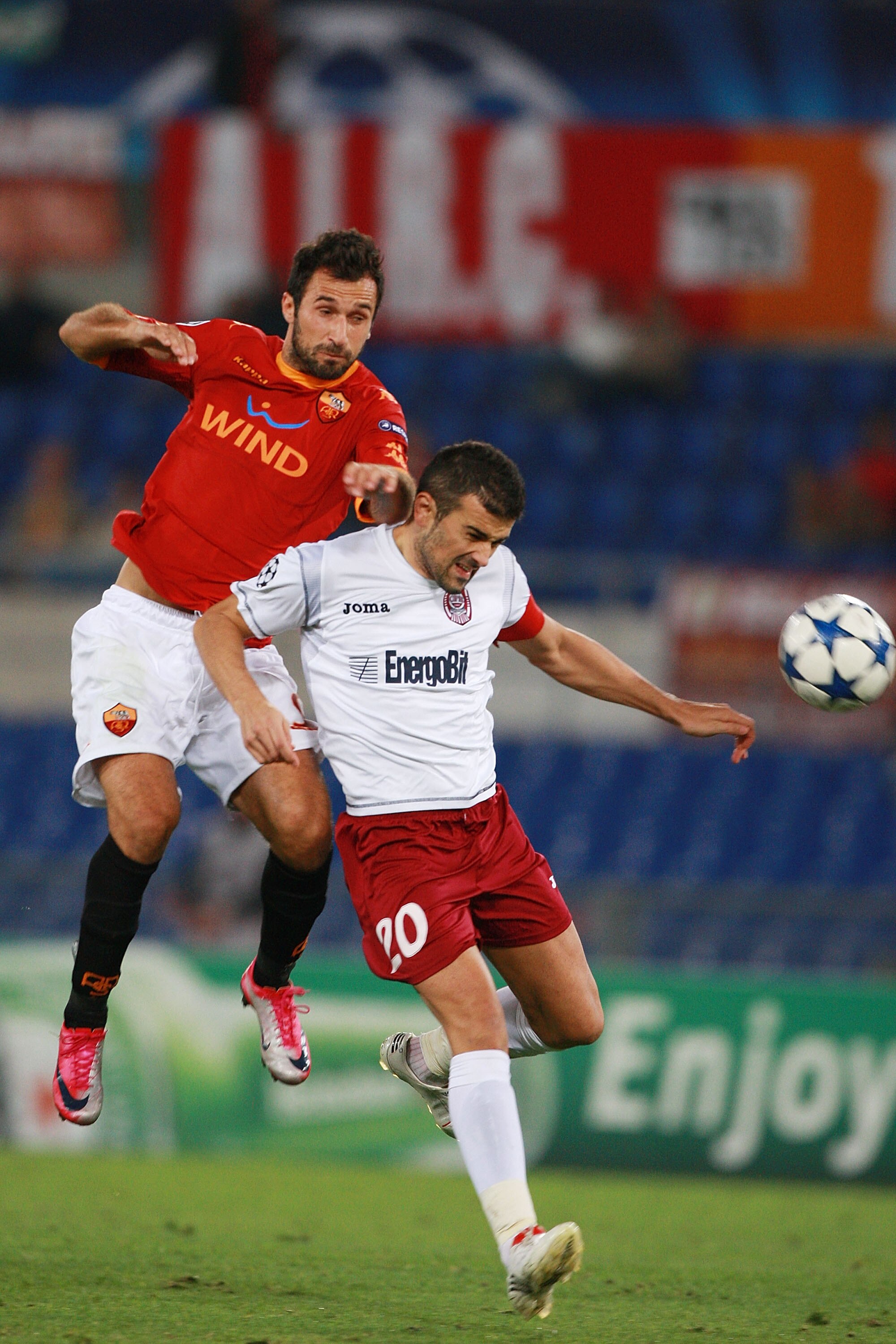 ROME - SEPTEMBER 28:  Mirko Vucinic (UP) of AS Roma competes for the ball with Cadu of CFR Cluj during the UEFA Champions League group E match between AS Roma and CFR Cluj at Stadio Olimpico on September 28, 2010 in Rome, Italy.  (Photo by Paolo Bruno/Get