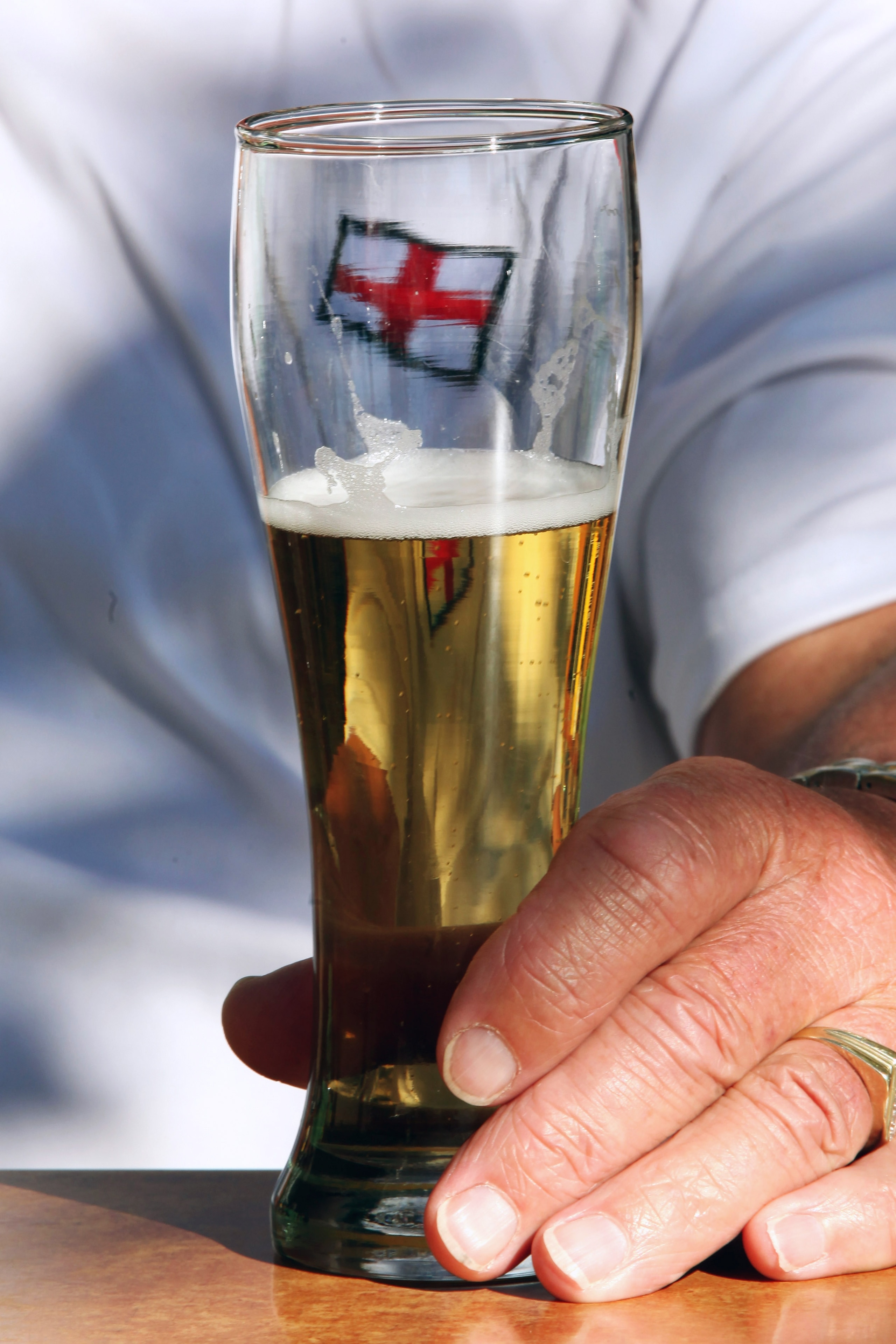 BLOEMFONTEIN, SOUTH AFRICA - JUNE 26:  An England fan sits at a table with a half full glass of beer on the Waterfront on June 26, 2010 in Bloemfontein, South Africa. England play Germany tomorrow in the last 16 knockout stage of the FIFA 2010 World Cup c