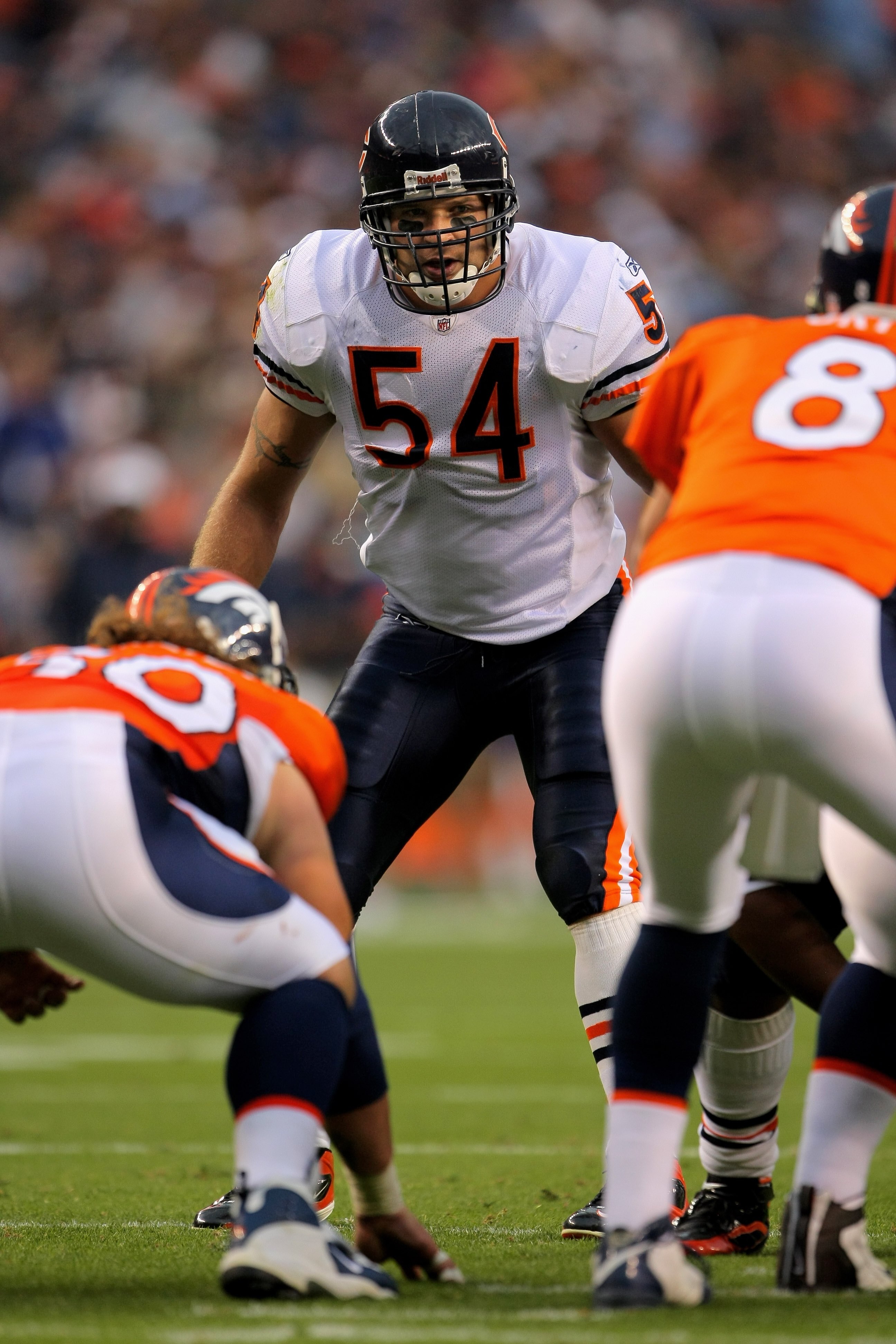 DENVER - AUGUST 30:  Line backer Brian Urlacher #54 of the Chicago Bears awaits the snap against quarterback Kyle Orton #8 of the Denver Broncos during preseason NFL action at INVESCO Field at Mile High on August 30, 2009 in Denver, Colorado. The Bears de