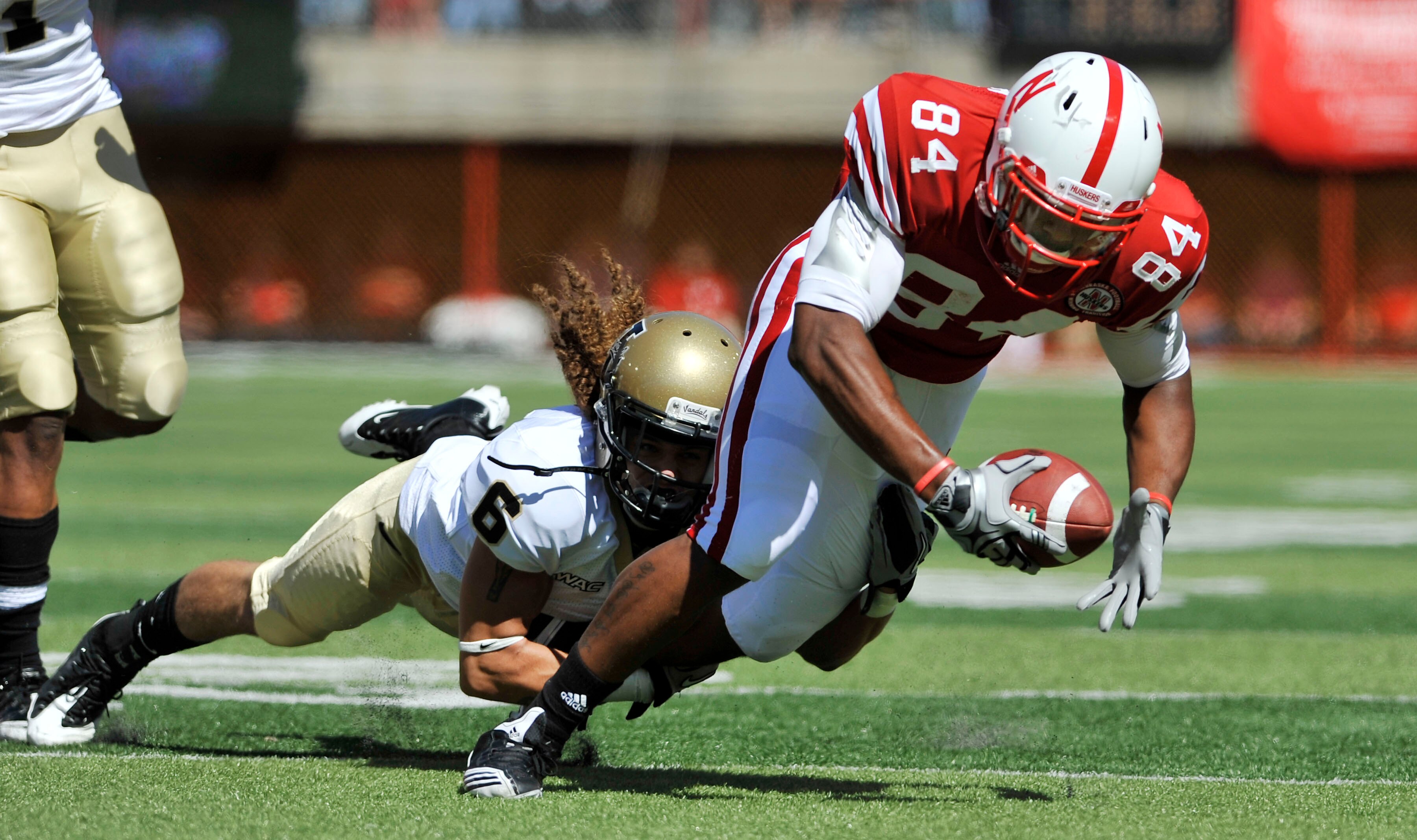 LINCOLN, NEBRASKA - SEPTEMBER 11: Nebraska Cornhuskers wide receiver Brandon Kinnie #84 gets tripped up by Idaho Vandals cornerback Aaron Grymes #6 during first half action of their game at Memorial Stadium on September 4, 2010 in Lincoln, Nebraska. Nebra