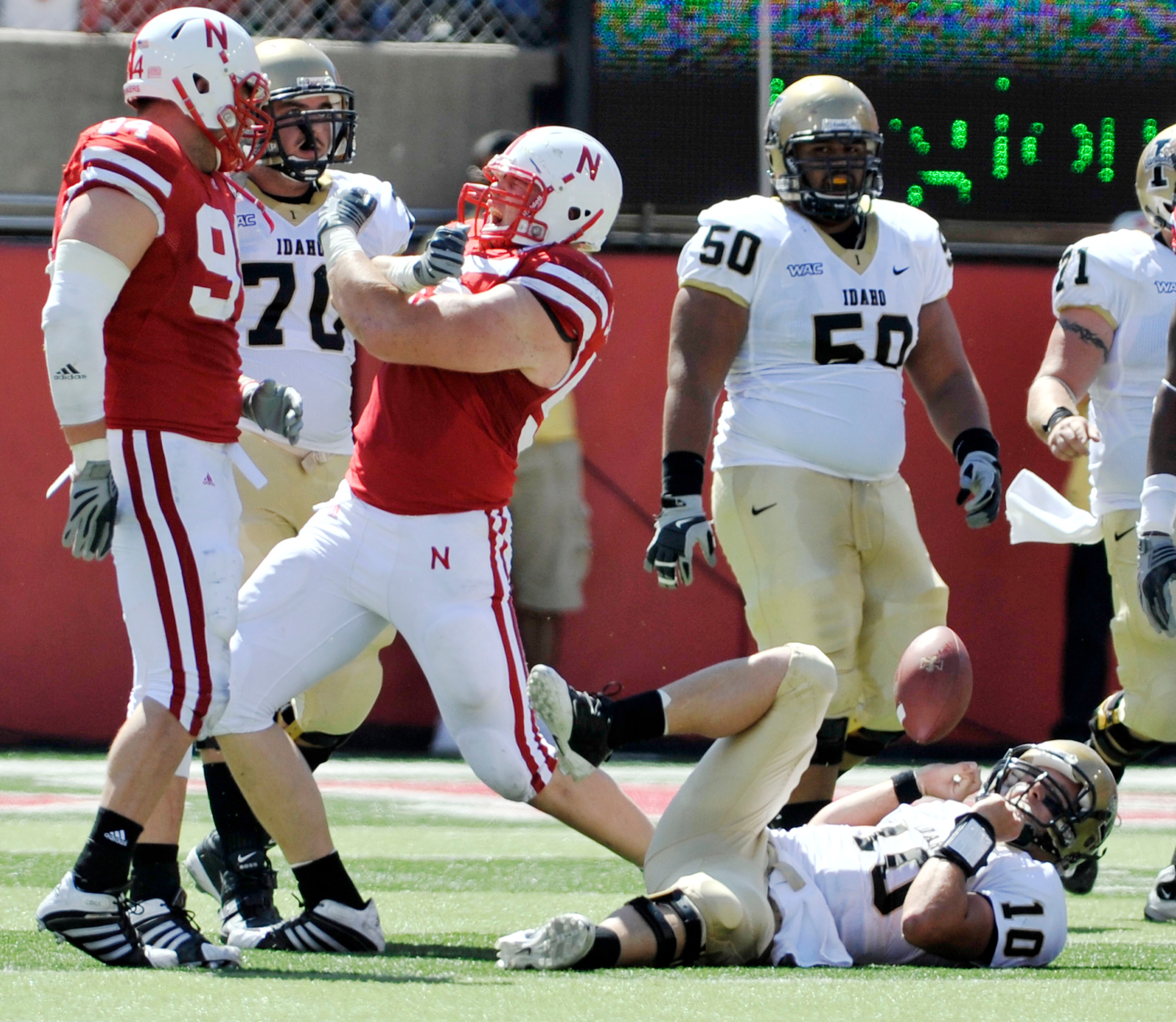 LINCOLN, NEBRASKA - SEPTEMBER 11: Idaho Vandals quarterback Nathan Enderle #10 looks up from the turf as Nebraska Cornhuskers defensive tackle Baker Steinkuhler #55 and Nebraska Cornhuskers defensive tackle Jared Crick celebrate a sack during first half a