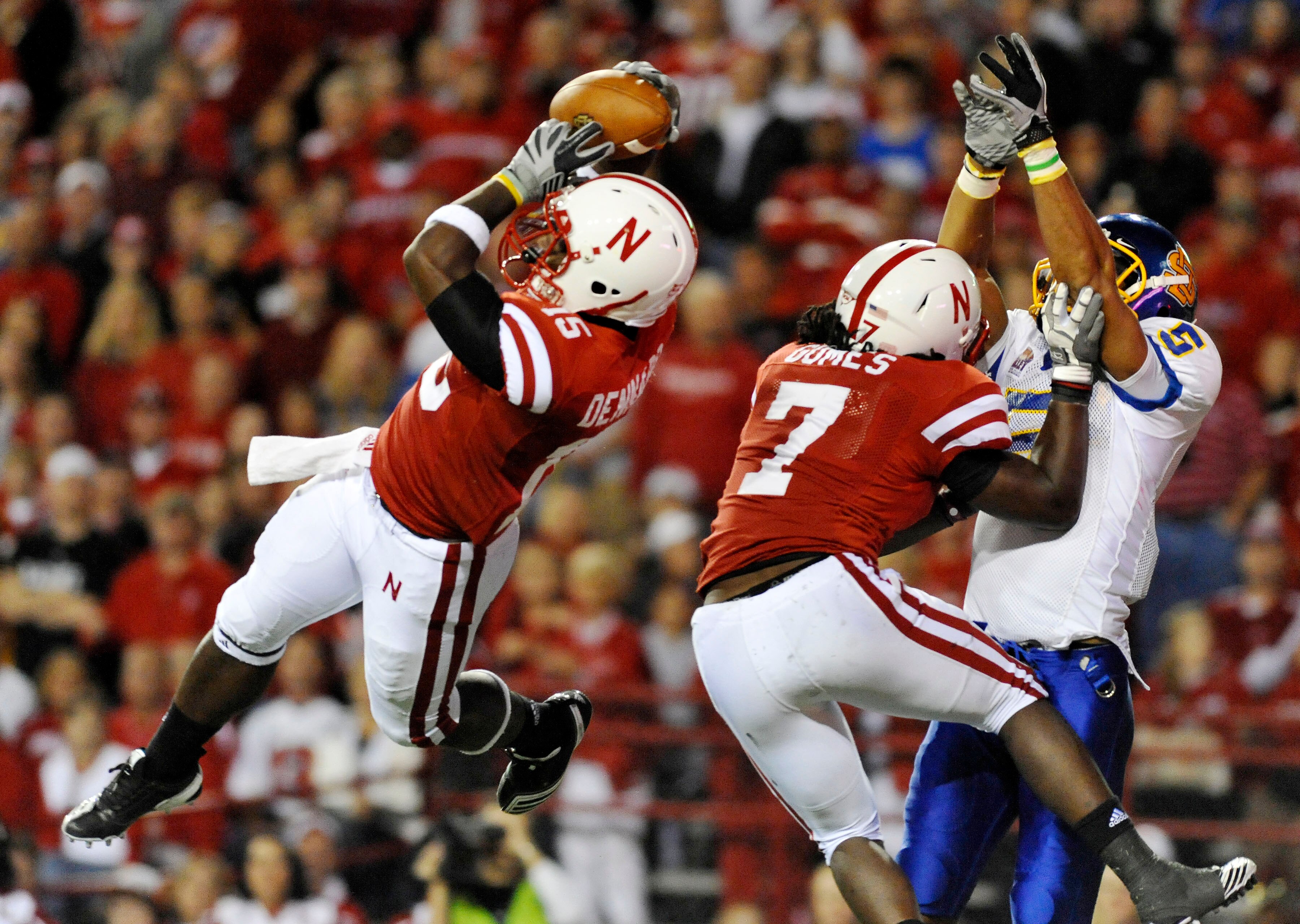 LINCOLN, NB - SEPTEMBER 25: Cornerback Alfonzo Dennard #15 of the Nebraska Cornuskers intercepts a ball from  wide receiver Aaron Rollin #5 of the South Dakota State Jackrabbits during second half action of their game at Memorial Stadium on September 25,