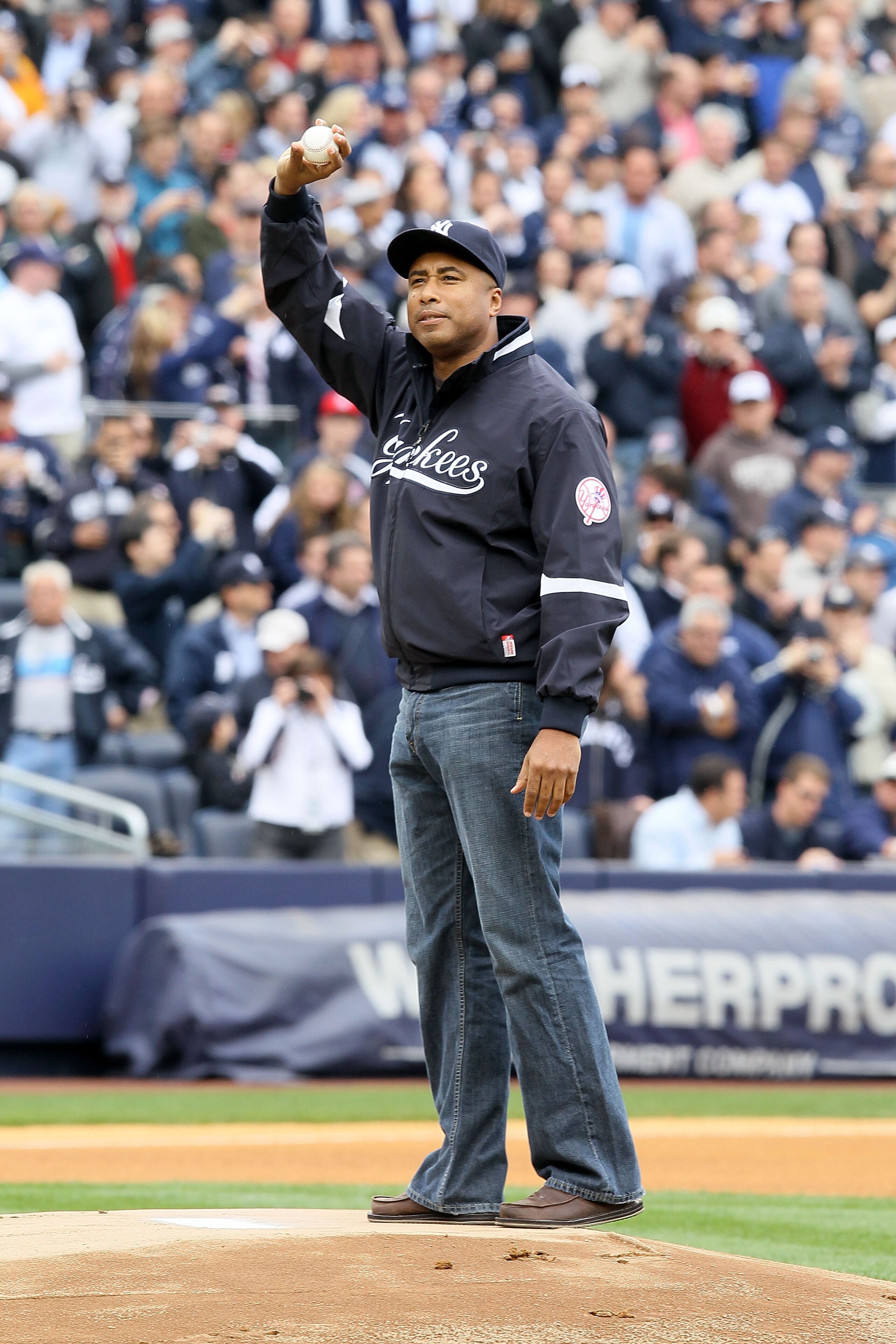 NEW YORK - APRIL 13:  Bernie Williams, former player for the New York Yankees, acknowledges the fans as he gets set to throw out the ceremonial first pitch against the Los Angeles Angels of Anaheim during the Yankees home opener at Yankee Stadium on April