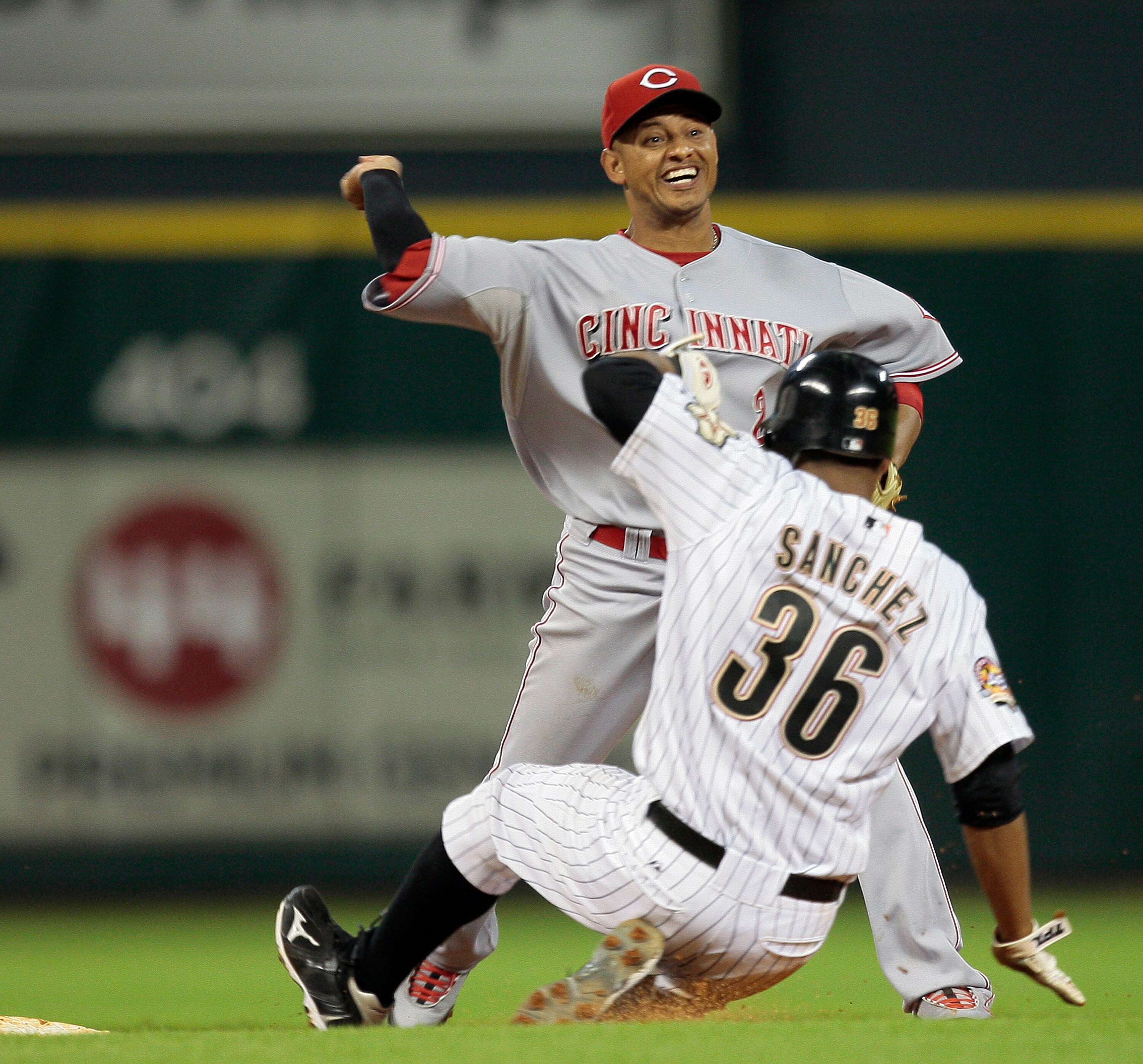 HOUSTON - JULY 23:  Shortstop Orlando Cabrera #2 of the Cincinnati Reds relays the throw to first base as Angel Sanchez #36 of the Houston  Astros attempts to break up the double play at Minute Maid Park on July 23, 2010 in Houston, Texas.  (Photo by Bob 