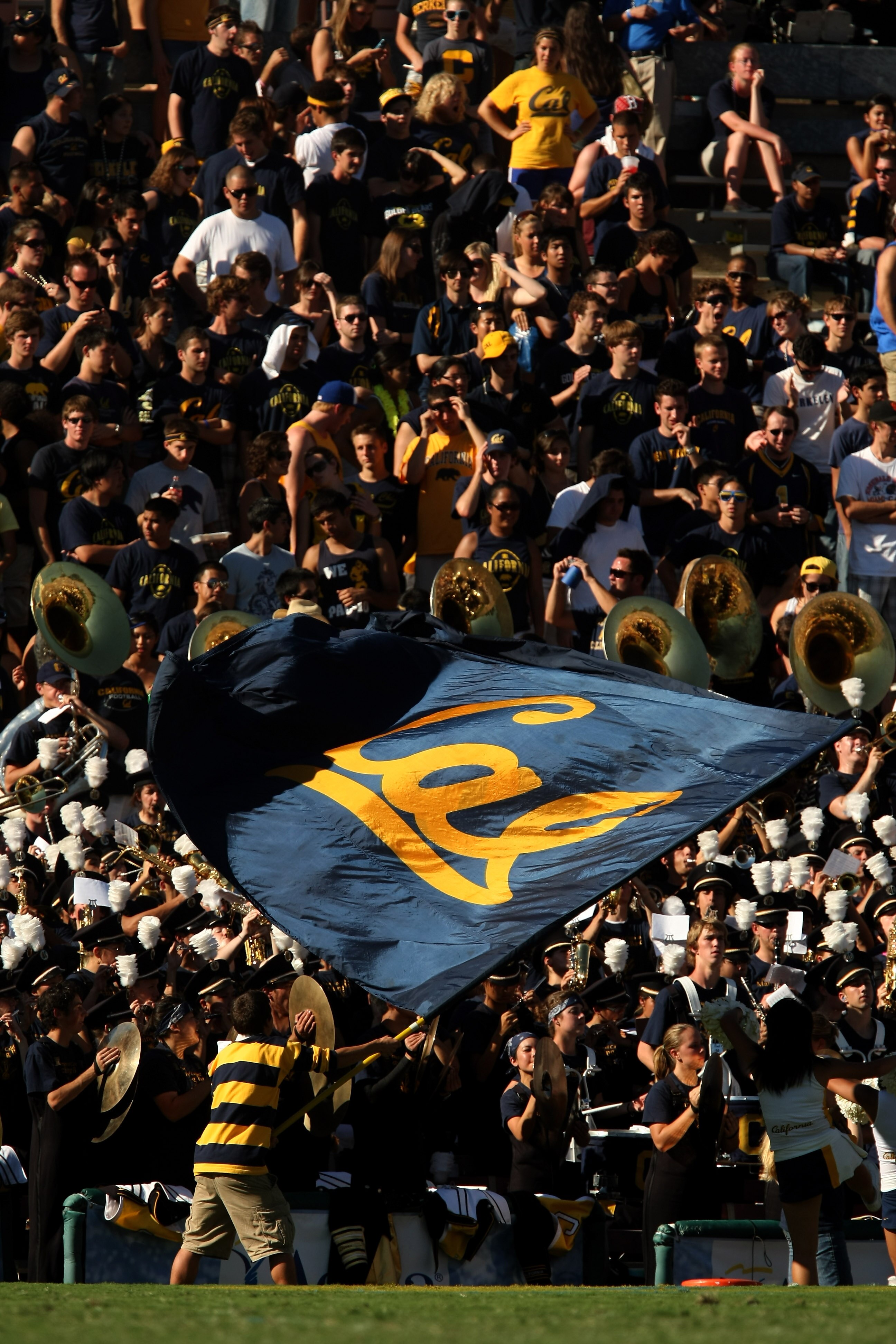 PASADENA, CA - OCTOBER 17:  A California Golden Bears cheerleader waves a flag in front of the Cal band and visitor's section in the game with the UCLA Bruins on October 17, 2009 at the Rose Bowl in Pasadena, California.   Cal won 45-26.  (Photo by Stephe