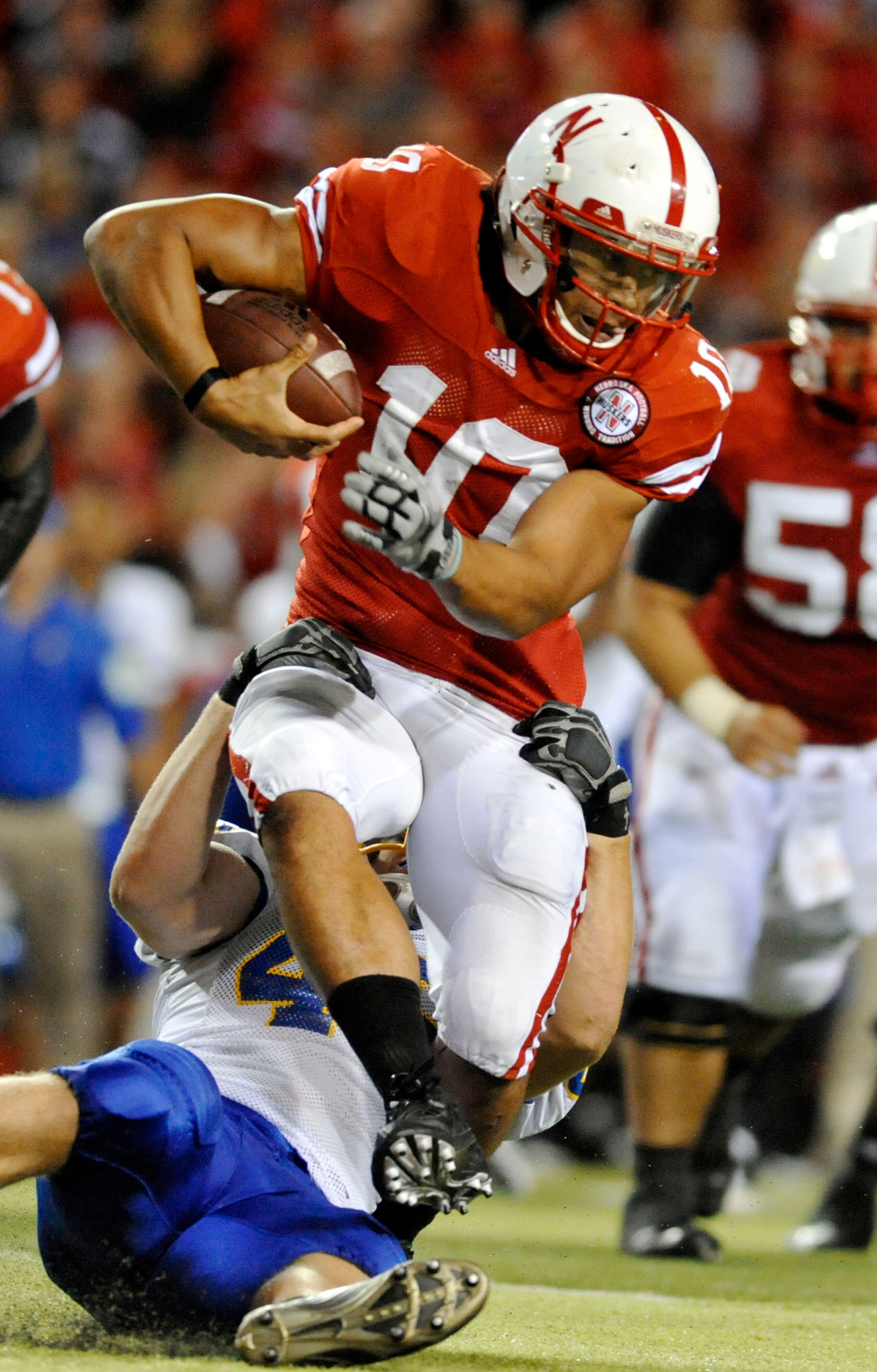 LINCOLN, NE - SEPTEMBER 25: Running back Roy Helu Jr. #10 of the Nebraska Cornuskers tries to slip the grip of defensive tackle Jake Steffen #46 of the South Dakota State Jackrabbits during second half action of their game at Memorial Stadium on September