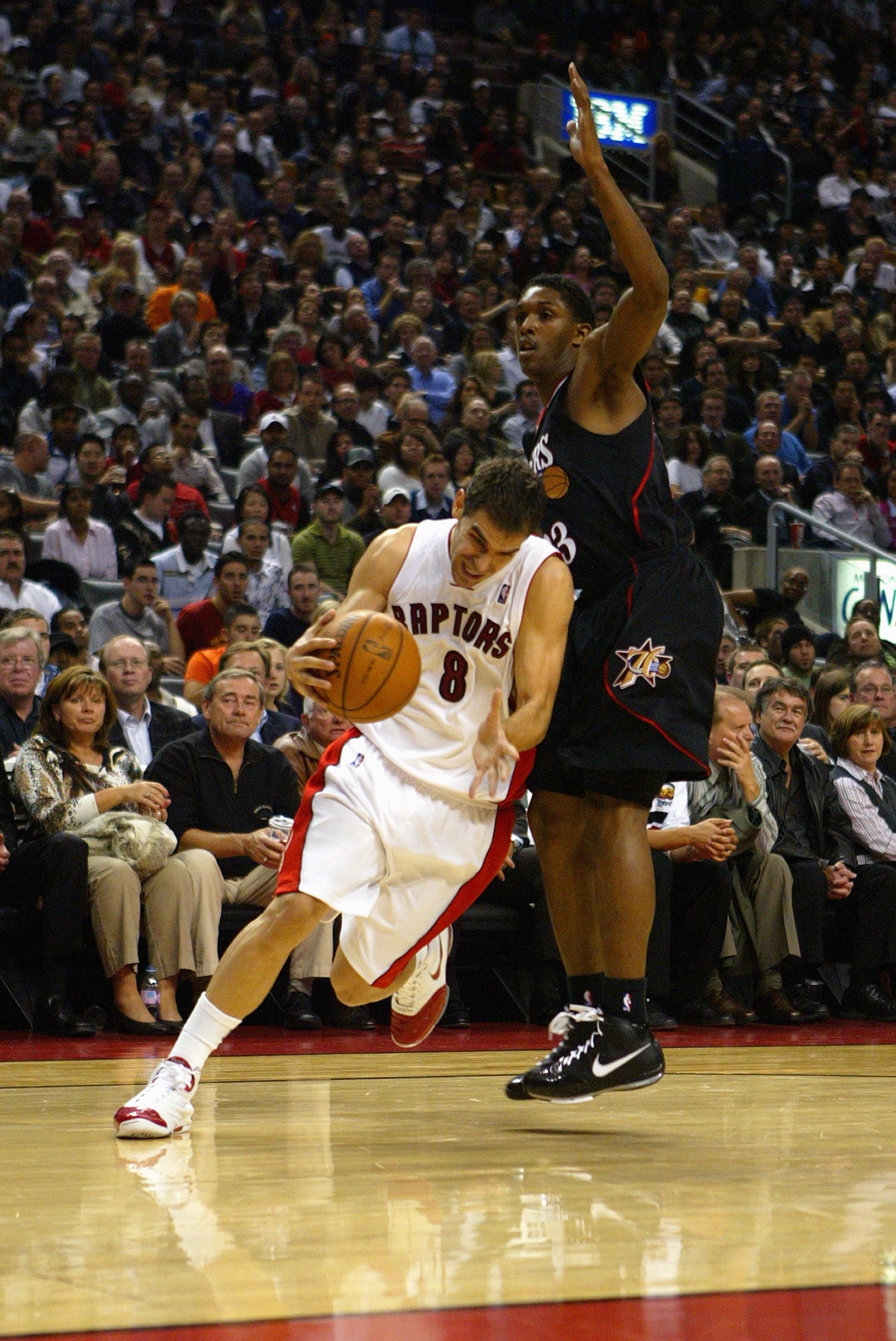TORONTO - OCTOBER 31:  Jose Calderon #8 of the Toronto Raptors drives around Louis Williams #23 of the Philadelphia 76ers during a game at the Air Canada Centre on October 31, 2007 in Toronto, Ontario, Canada.  The Raptors won 106-97.  NOTE TO USER: User