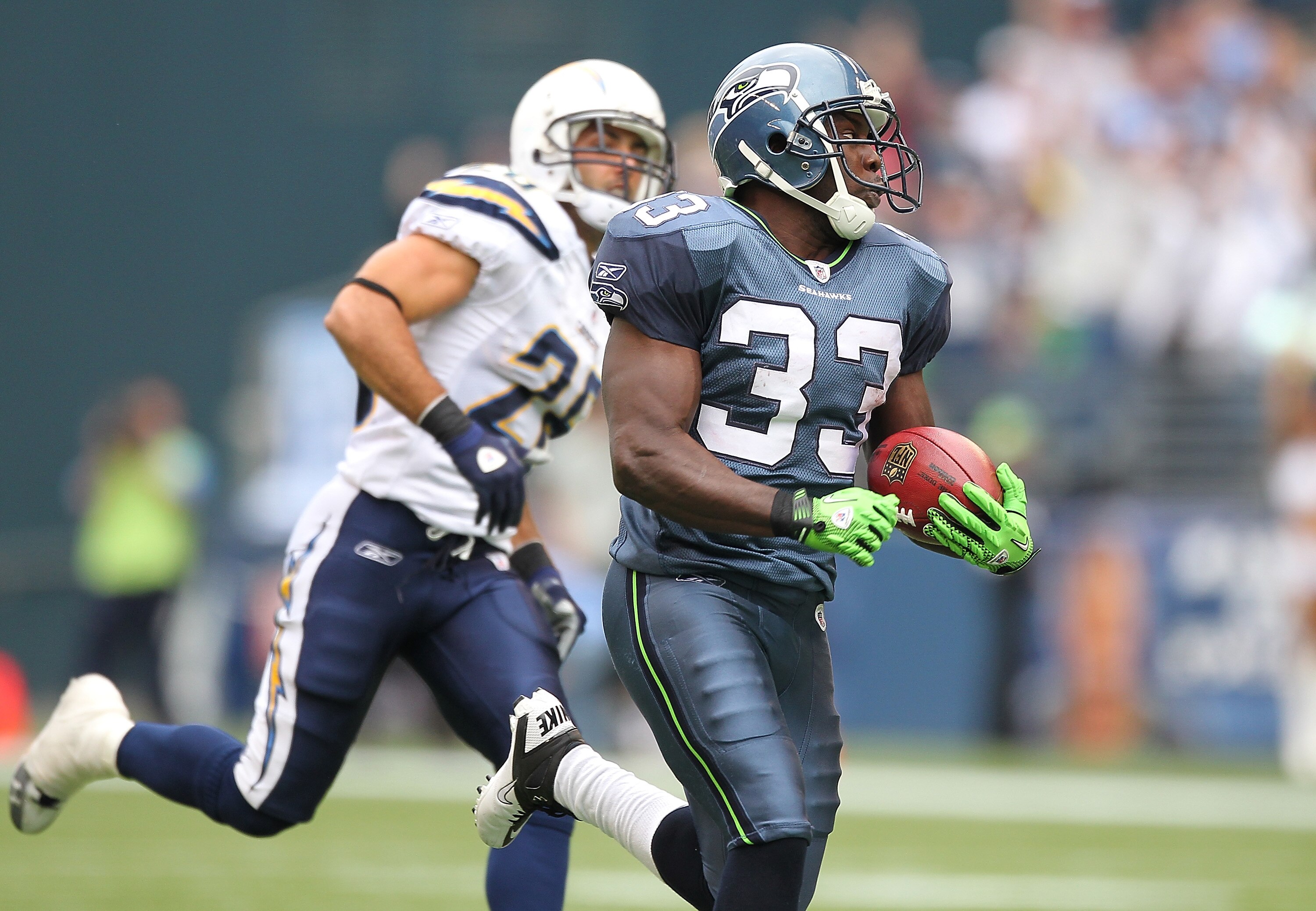 SEATTLE - SEPTEMBER 26:  Kick returner Leon Washington #33 of the Seattle Seahawks rushes for a 101 yard kickoff return for a touchdown in the third quarter against Steve Gregory #28 of the San Diego Chargers at Qwest Field on September 26, 2010 in Seattl