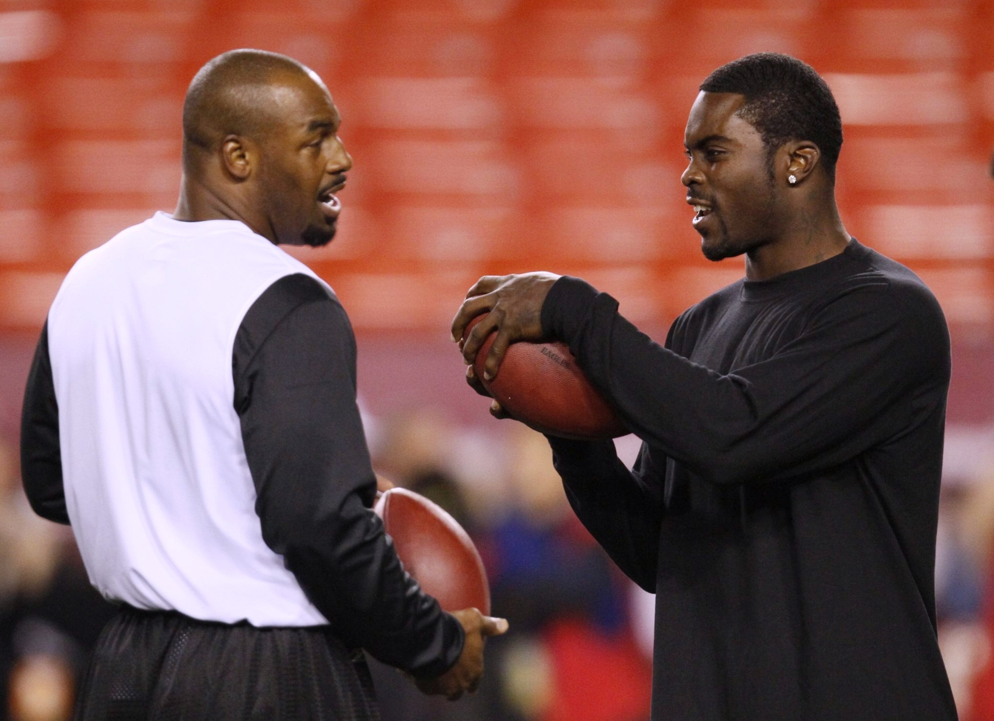 LANDOVER, MD - OCTOBER 26: Donovan McNabb #5 of the Philadelphia Eagles (L) talks with teammate Michael Vick #7 (R) as they warm up prior to the game against the Washington Redskins at FedEx Field October 26, 2009 in Landover, Maryland. (Photo by Win McN LANDOVER, MD - OCTOBER 26: Donovan McNabb #5 of the Philadelphia Eagles (L) talks with teammate Michael Vick #7 (R) as they warm up prior to the game against the Washington Redskins at FedEx Field October 26, 2009 in Landover, Maryland. (Photo by Win McN