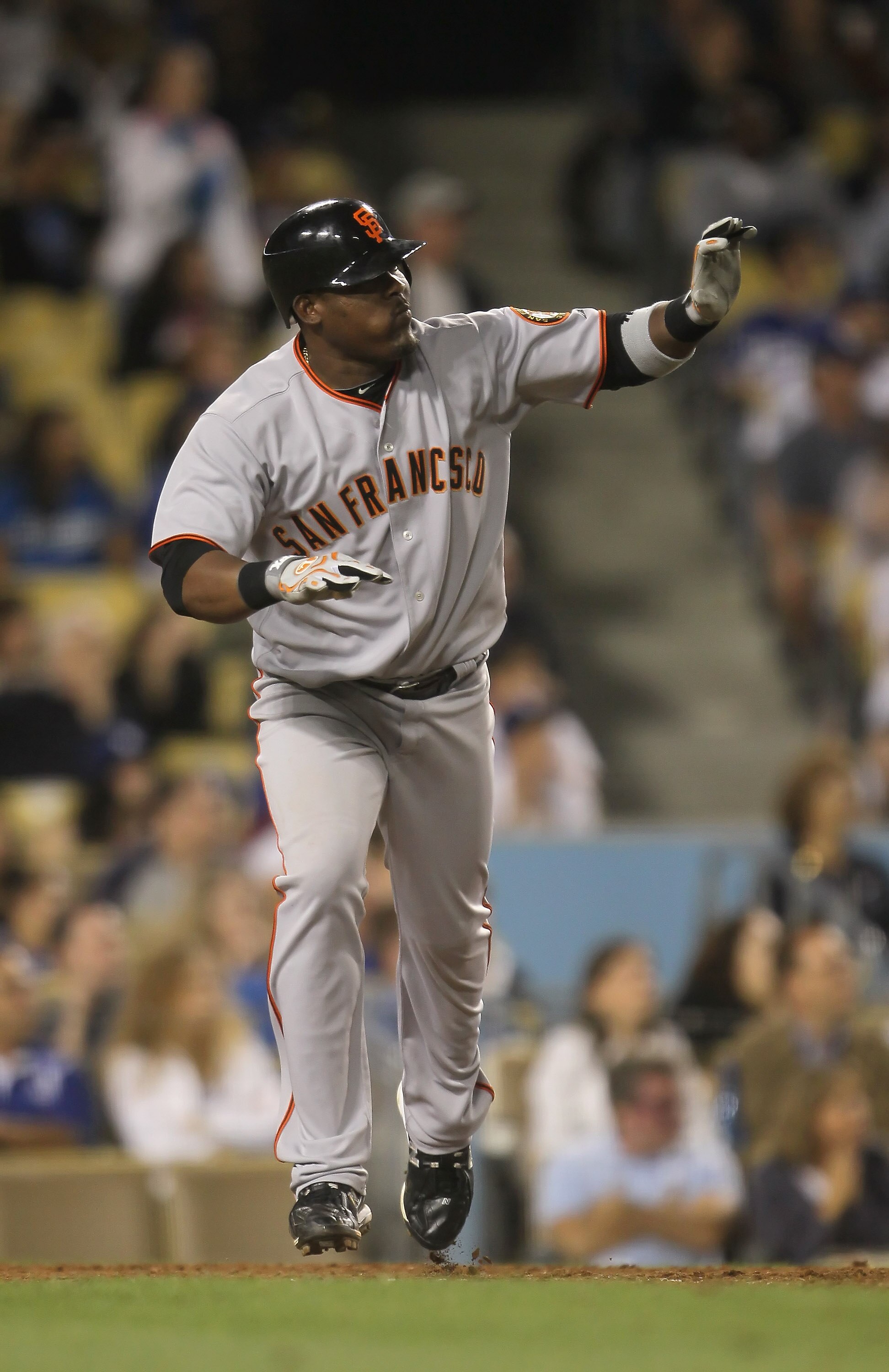 LOS ANGELES, CA - SEPTEMBER 04:  Juan Uribe #5 of the San Francisco Giants begins to run to first base after hitting a two-run home run against the Los Angeles Dodgers in the ninth inning at Dodger Stadium on September 4, 2010 in Los Angeles, California. 