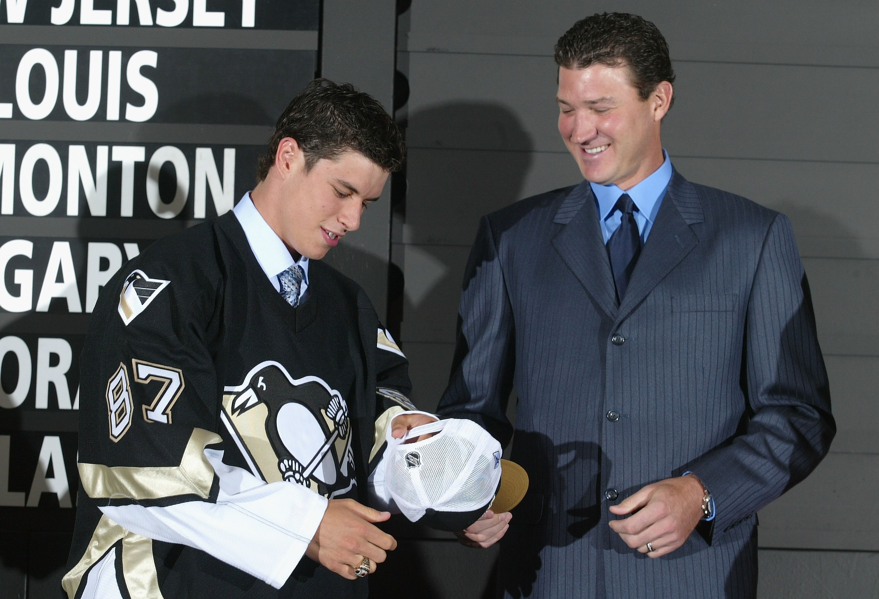 OTTAWA, ONT - JULY 30:  (L-R) First overall draft pick Sidney Crosby accepts a hat and jersey from Mario Lemieux of the Pittsburgh Penguins during the 2005 National Hockey League Draft on July 30, 2005 at the Westin Hotel in Ottawa, Canada.  (Photo by And