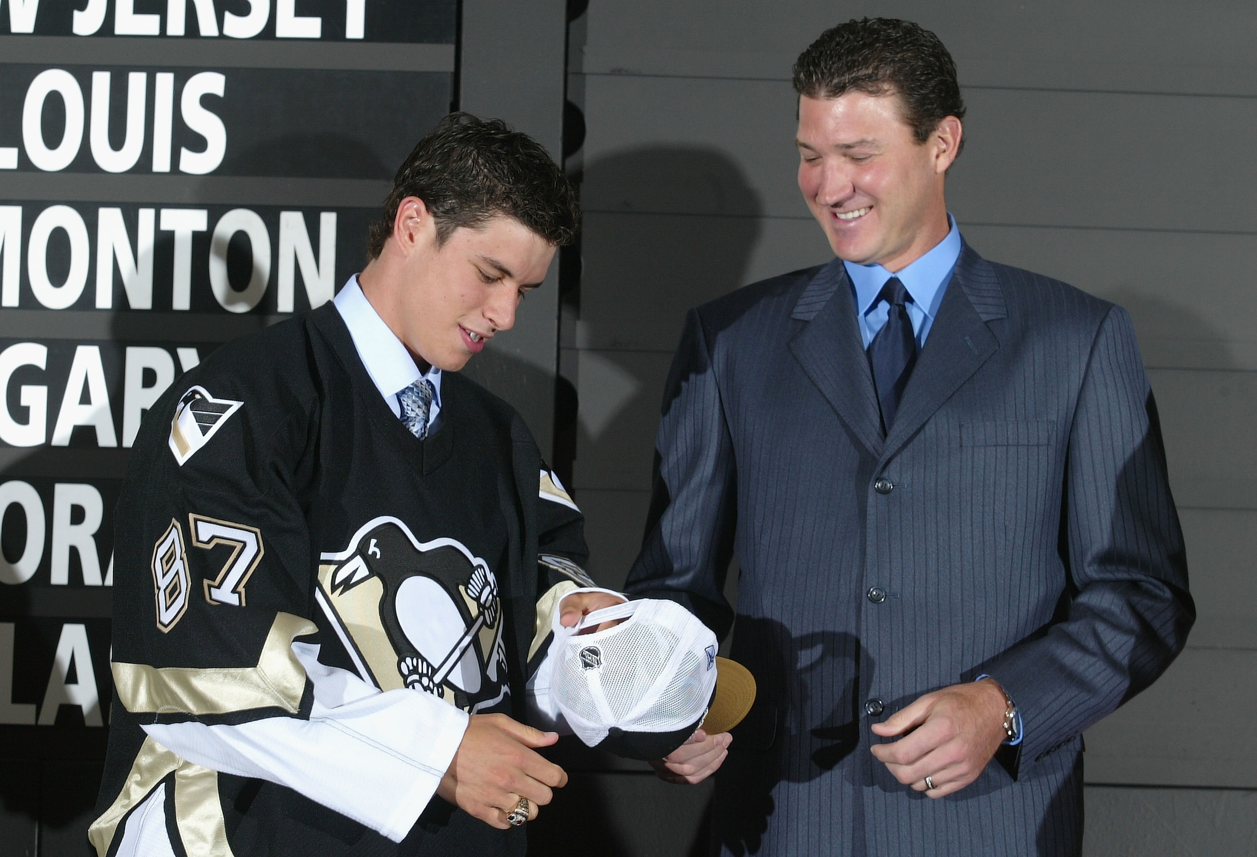 OTTAWA, ONT - JULY 30:  (L-R) First overall draft pick Sidney Crosby accepts a hat and jersey from Mario Lemieux of the Pittsburgh Penguins during the 2005 National Hockey League Draft on July 30, 2005 at the Westin Hotel in Ottawa, Canada.  (Photo by And