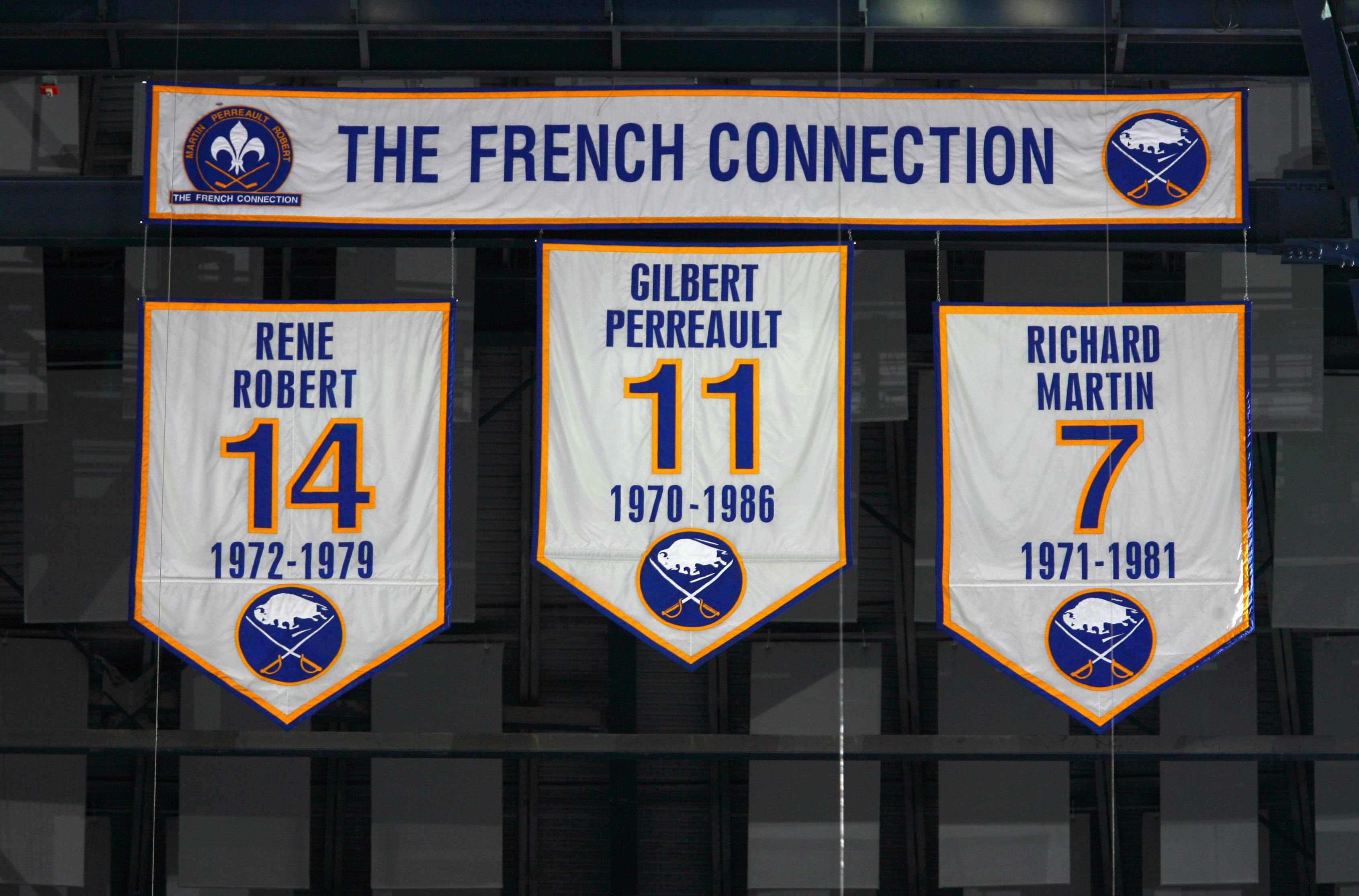 BUFFALO, NY - OCTOBER 3:  Banners of the numbers of the former Buffalo Sabres 'French Connection' line of Rene Robert #14, Gilbert Perreault #11 and Richard Martin #7 hang from the rafters during the NHL game between the Buffalo Sabres and the Montreal Ca