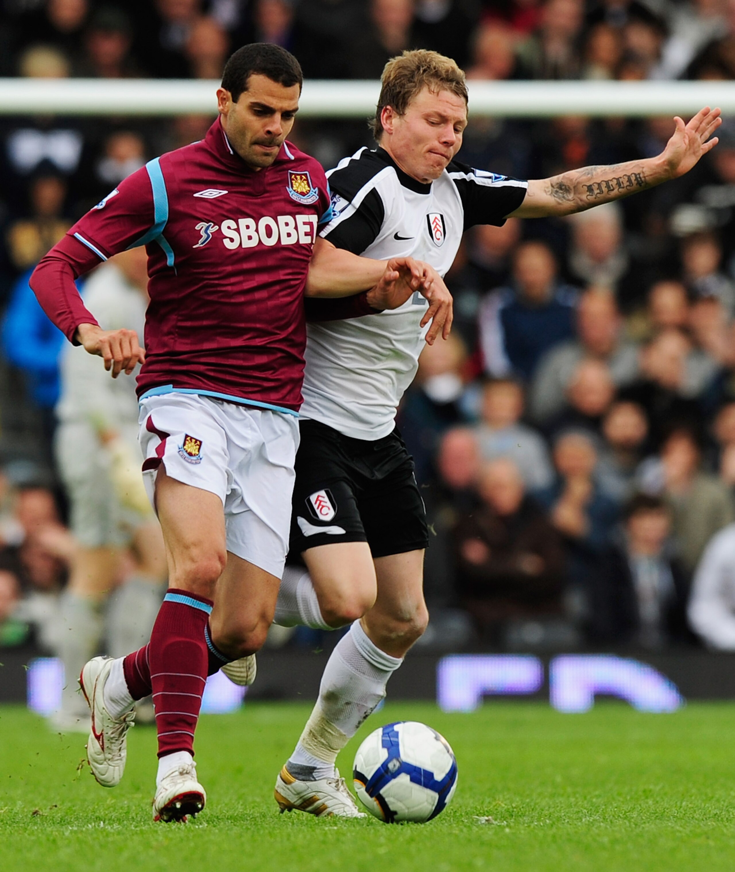 LONDON, ENGLAND - MAY 02:  Araujo Ilan of West Ham United battles with Bjorn Helge Riise of Fulham during the Barclays Premier League match between Fulham and West Ham United at Craven Cottage on May 2, 2010 in London, England.  (Photo by Jamie McDonald/G