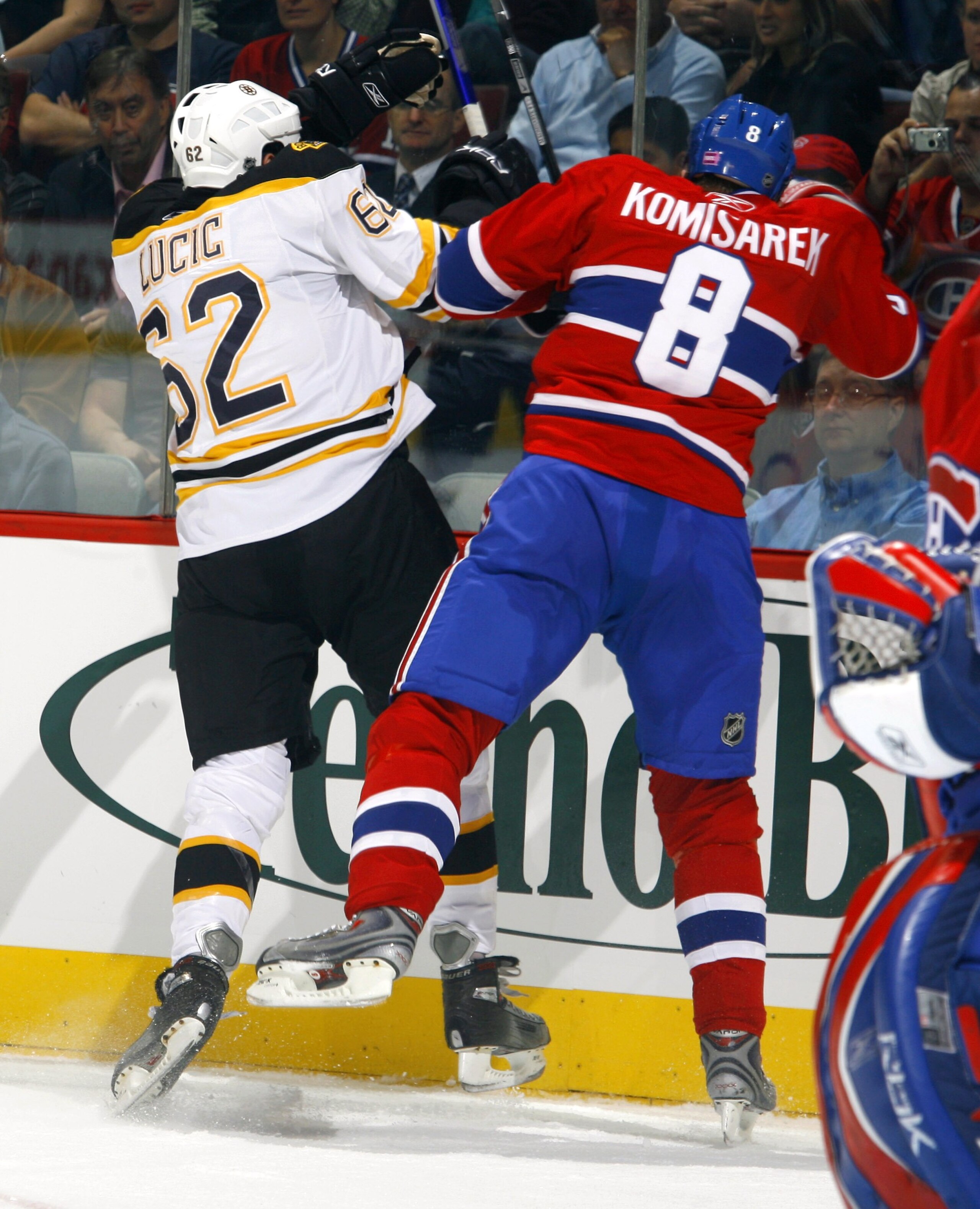 MONTREAL, CANADA - OCTOBER 22:  Milan Lucic #62 of the Boston Bruins throws a big hit on Michael Komisarek #8 of the Montreal Canadiens during first period action on October 22, 2007 at the Bell Centre in Montreal, Quebec. The Montreal Canadiens lead the 