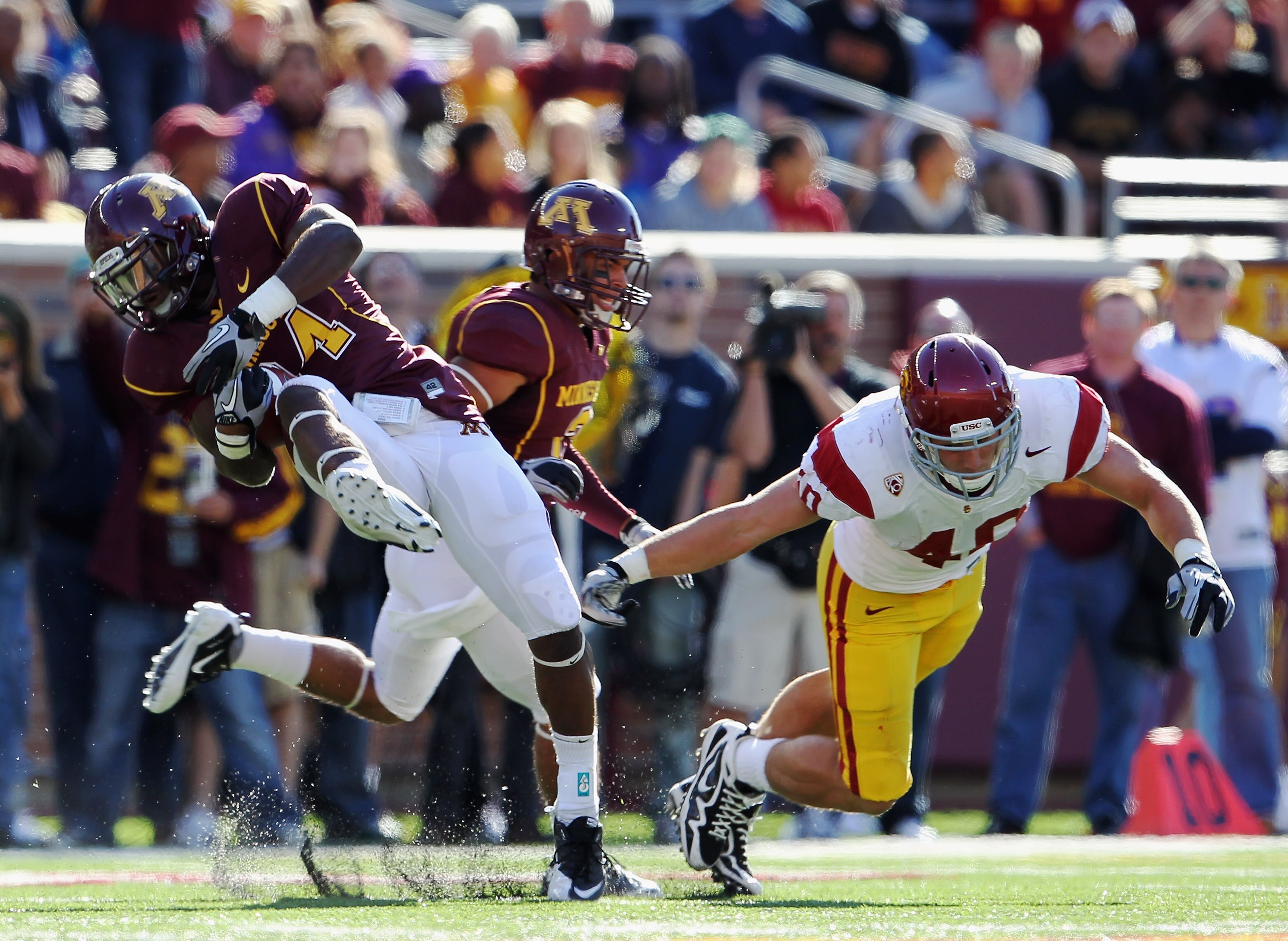 MINNEAPOLIS - SEPTEMBER 18:  James Manuel #24 of the Minnesota Golden Gophers intercepts a pass intended for Rhett Ellison #40 of the USC Trojans during the game on September 18, 2010 at TCF Bank Stadium in Minneapolis, Minnesota.  (Photo by Jamie Squire/