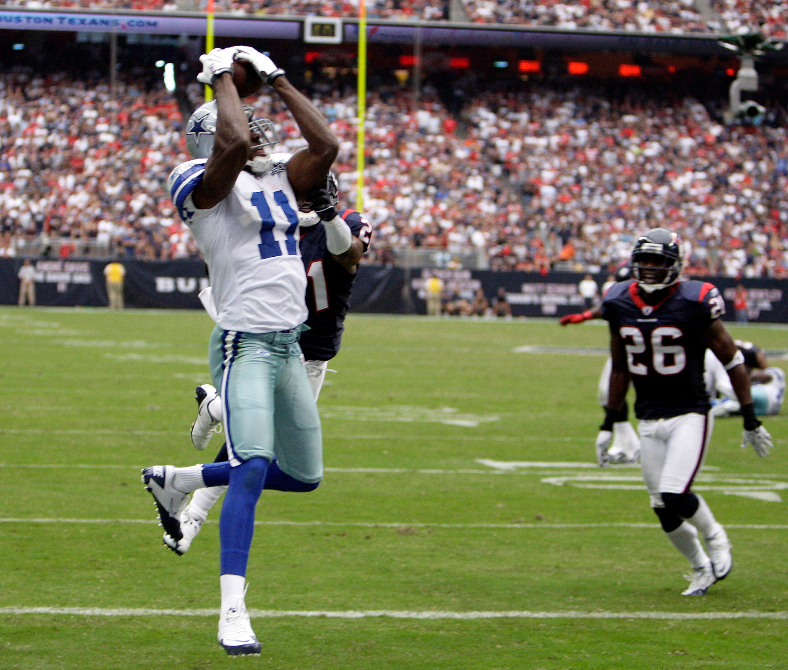 HOUSTON - SEPTEMBER 26:  Wide receiver Roy Williams #11 of the Dallas Cowboys catches a pass for a touchdown as he beats cornerback Brice McCain #21 of the Houston Texans in the third quarter at Reliant Stadium on September 26, 2010 in Houston, Texas.  (P