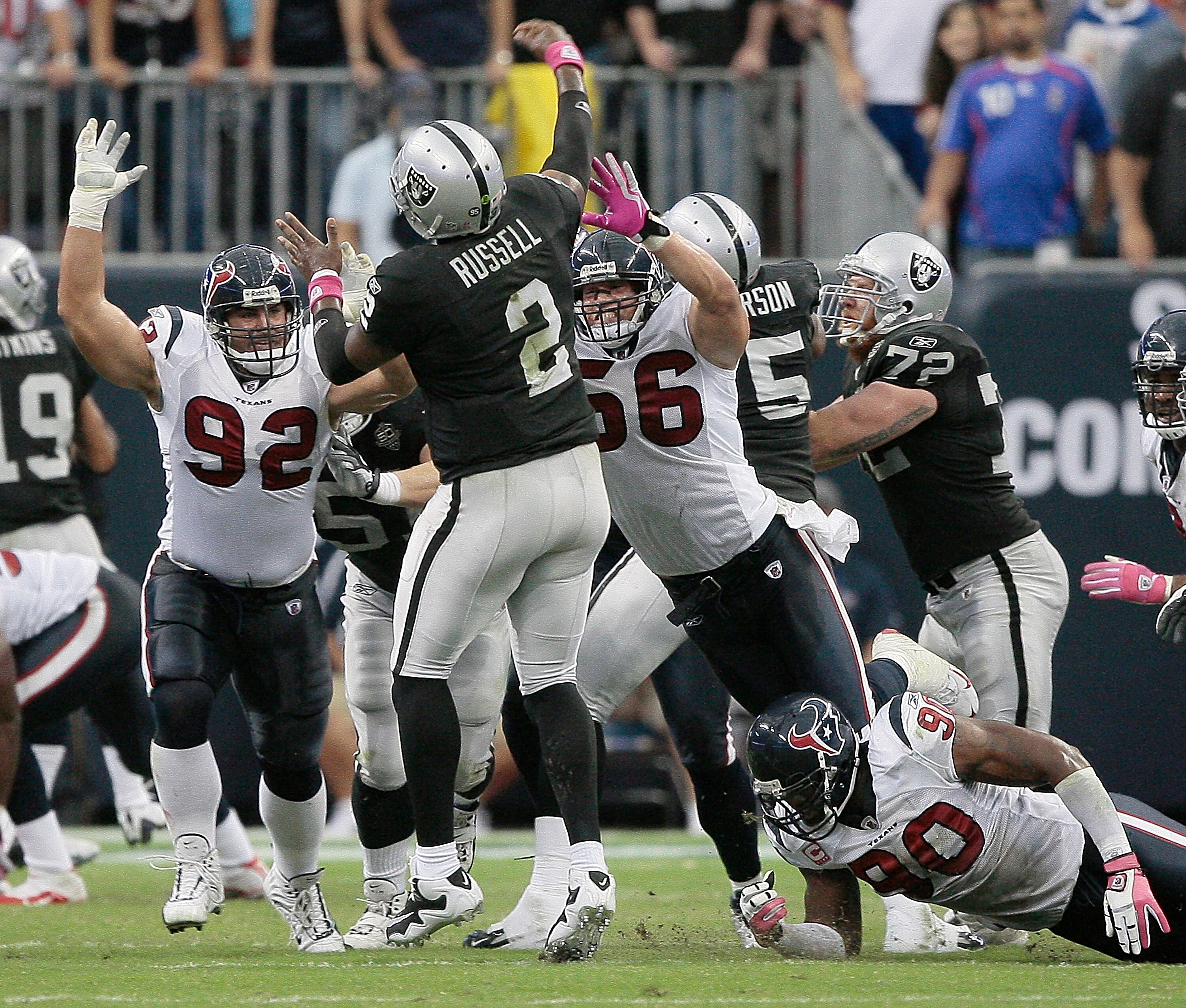 HOUSTON - OCTOBER 04: Quarterback JeMarcus Russell #2 of the Oakland Raiders releases the ball as he is pressured by linebacker Brian Cushing #56 and defensive tackle Jeff Zgonina #92 of the Houston Texans at Reliant Stadium on October 4, 2009 in Housto HOUSTON - OCTOBER 04: Quarterback JeMarcus Russell #2 of the Oakland Raiders releases the ball as he is pressured by linebacker Brian Cushing #56 and defensive tackle Jeff Zgonina #92 of the Houston Texans at Reliant Stadium on October 4, 2009 in Housto