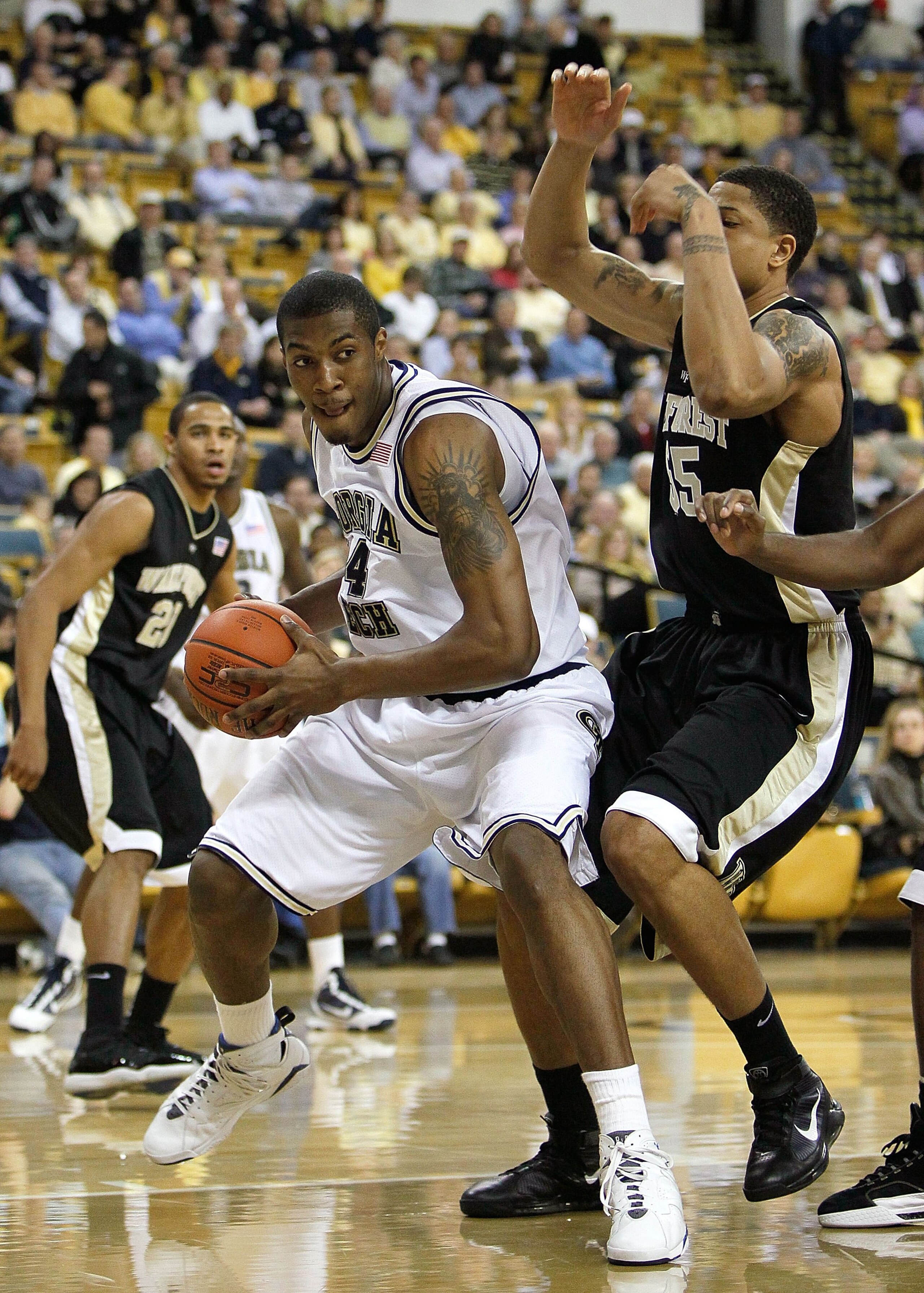 ATLANTA - JANUARY 28:  Derrick Favors #14 of the Georgia Tech Yellow Jackets against Tony Woods #55 of the Wake Forest Demon Deacons at Alexander Memorial Coliseum on January 28, 2010 in Atlanta, Georgia.  (Photo by Kevin C. Cox/Getty Images)