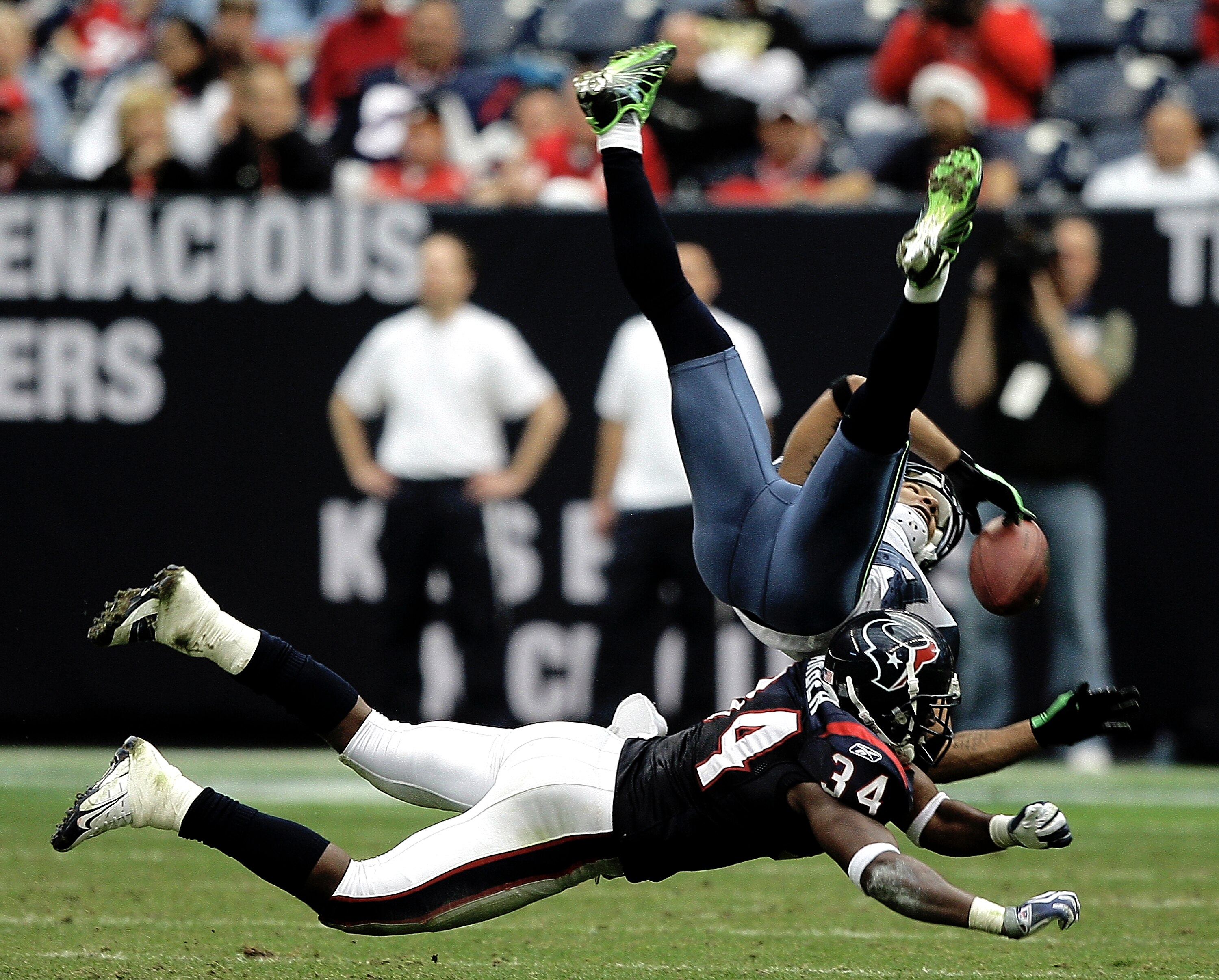 HOUSTON - DECEMBER 13: Wide receiver T.J. Houshmandzadeh #84 of the Seattle Seahawks has the ball knocked loose by strong safety Dominique Barber #34 of the Houston Texans in the fourth quarter at Reliant Stadium on December 13, 2009 in Houston, Texas. T HOUSTON - DECEMBER 13: Wide receiver T.J. Houshmandzadeh #84 of the Seattle Seahawks has the ball knocked loose by strong safety Dominique Barber #34 of the Houston Texans in the fourth quarter at Reliant Stadium on December 13, 2009 in Houston, Texas. T