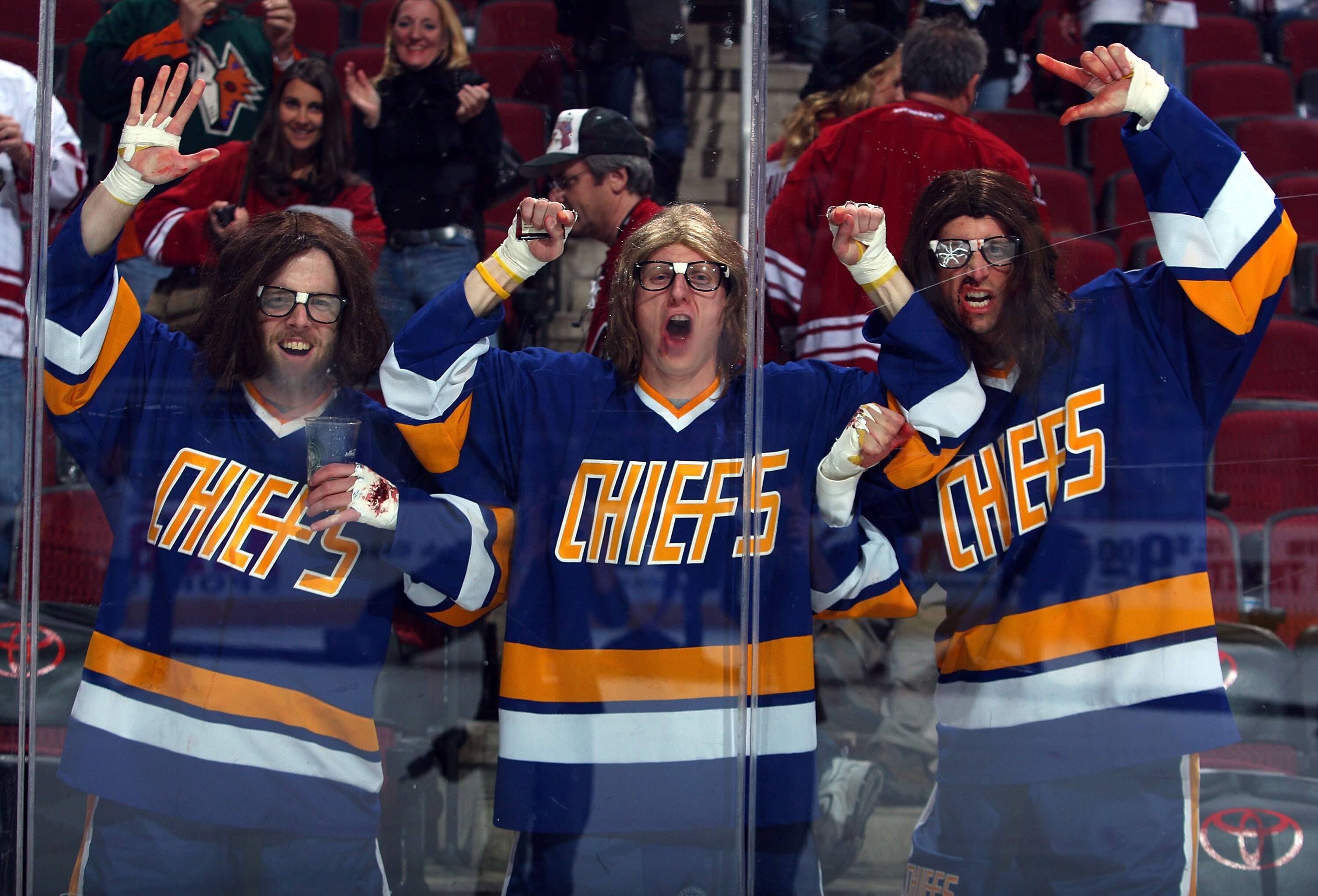 GLENDALE, AZ - JANUARY 14: Fans dressed as the Hanson Brothers cheer along the boards following the NHL game between the New Jersey Devils and the Phoenix Coyotes at Jobing.com Arena on January 14, 2010 in Glendale, Arizona. The Coyotes defeated the Dev GLENDALE, AZ - JANUARY 14: Fans dressed as the Hanson Brothers cheer along the boards following the NHL game between the New Jersey Devils and the Phoenix Coyotes at Jobing.com Arena on January 14, 2010 in Glendale, Arizona. The Coyotes defeated the Dev